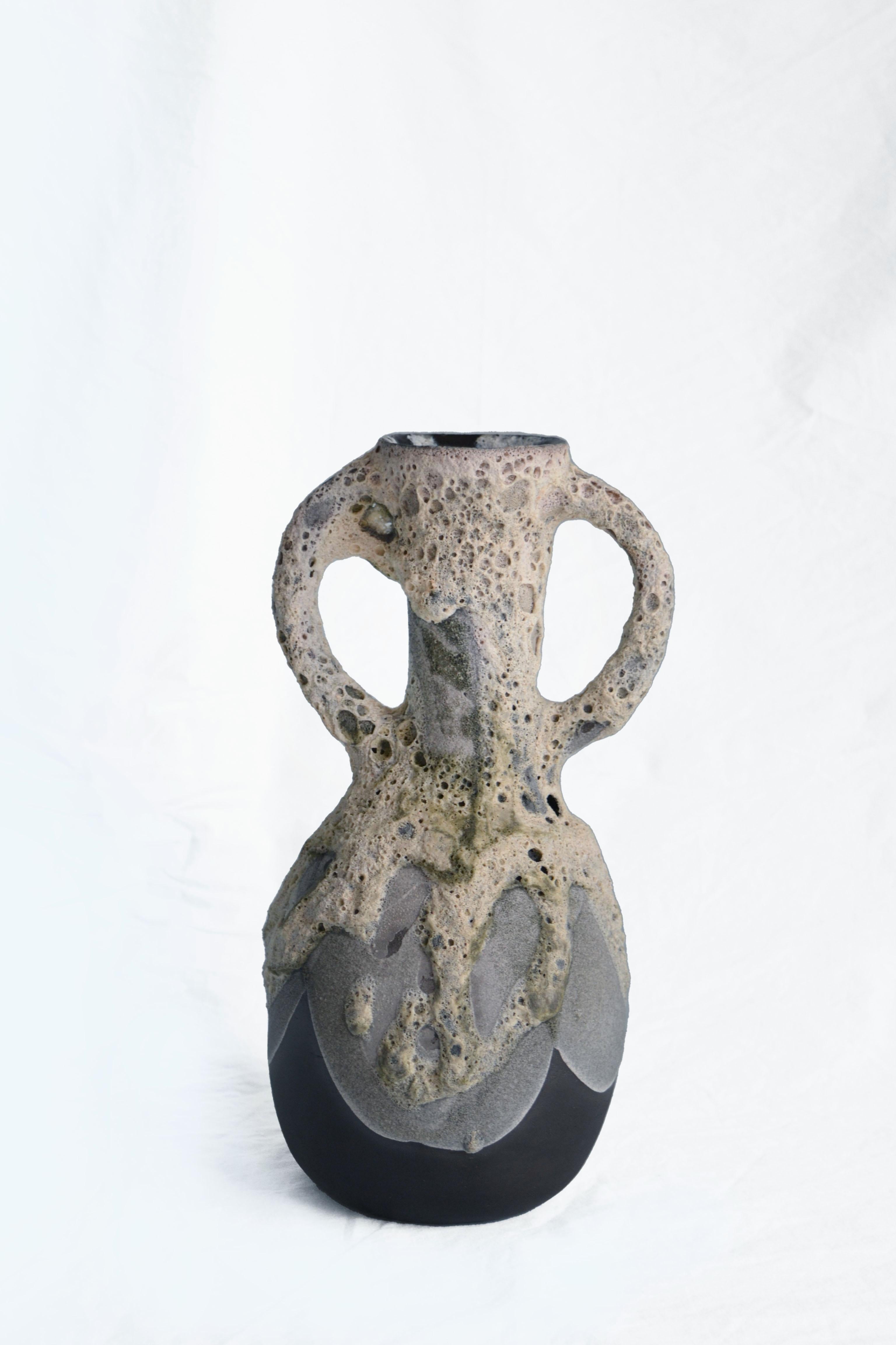 Carafe 3 vase by Anna Karountzou
Dimensions: W 16 x D 15 x H 30 cm
Materials: black stoneware clay, clear glaze inside, handmade crater glaze outside, fired at 1220

Born and based in Athens, Greece, with a background in conservation of works of