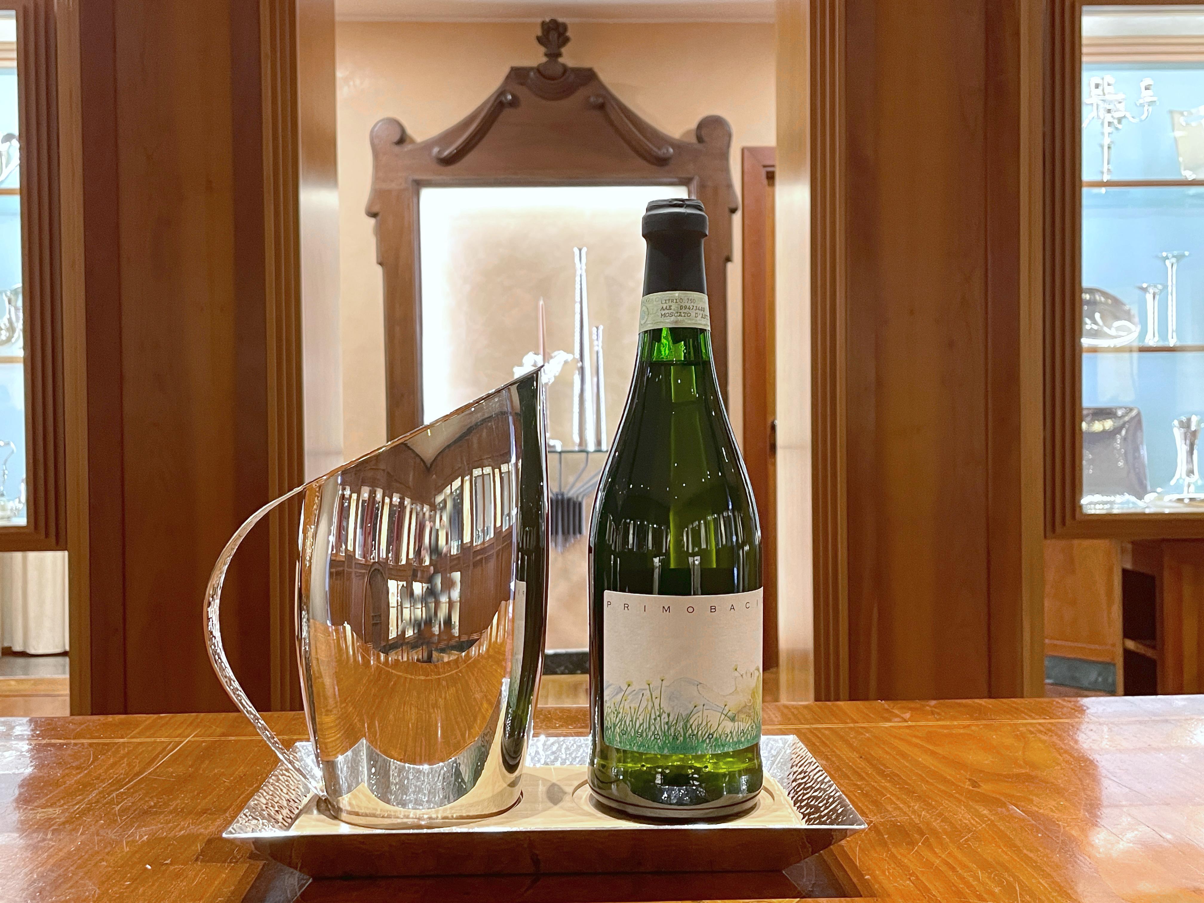 Attica Pampaloni carafe with silver plated and wood bottle tray
Tray size: (27 x 15 x 2.5) cm
Jug size: height 21 cm, base diameter 9 cm
Manufactured by Pampaloni Firenze - Made in Italy

Double finish, hammered handle and mirror polished smooth