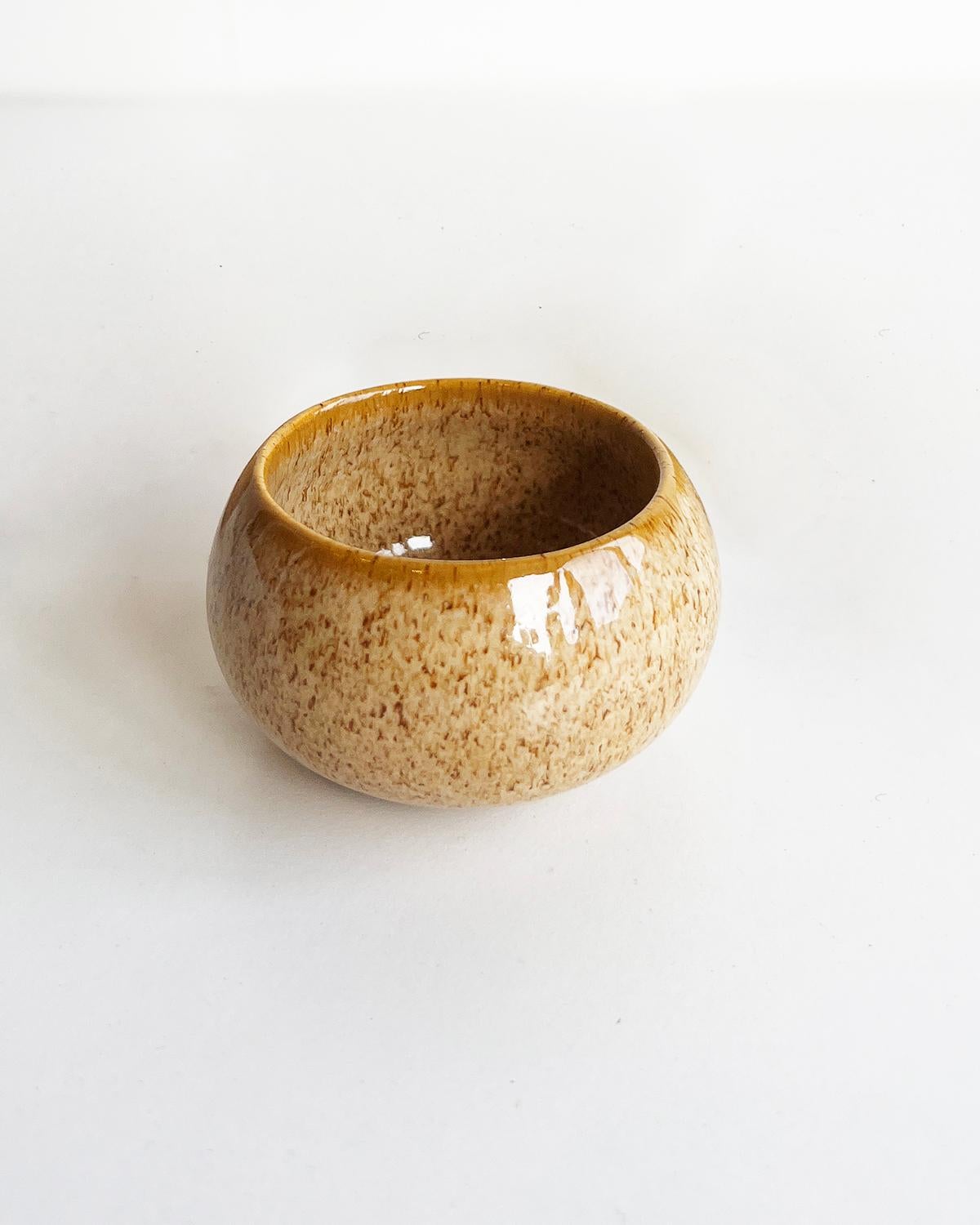 The perfect cups for sipping your favorite Mezcal. These handmade stoneware mezcal cups are the perfect addition to any kitchen or bar. Made in Mexico by skilled artisans, each cup has a unique caramel beige speckled glaze, adding an organic modern