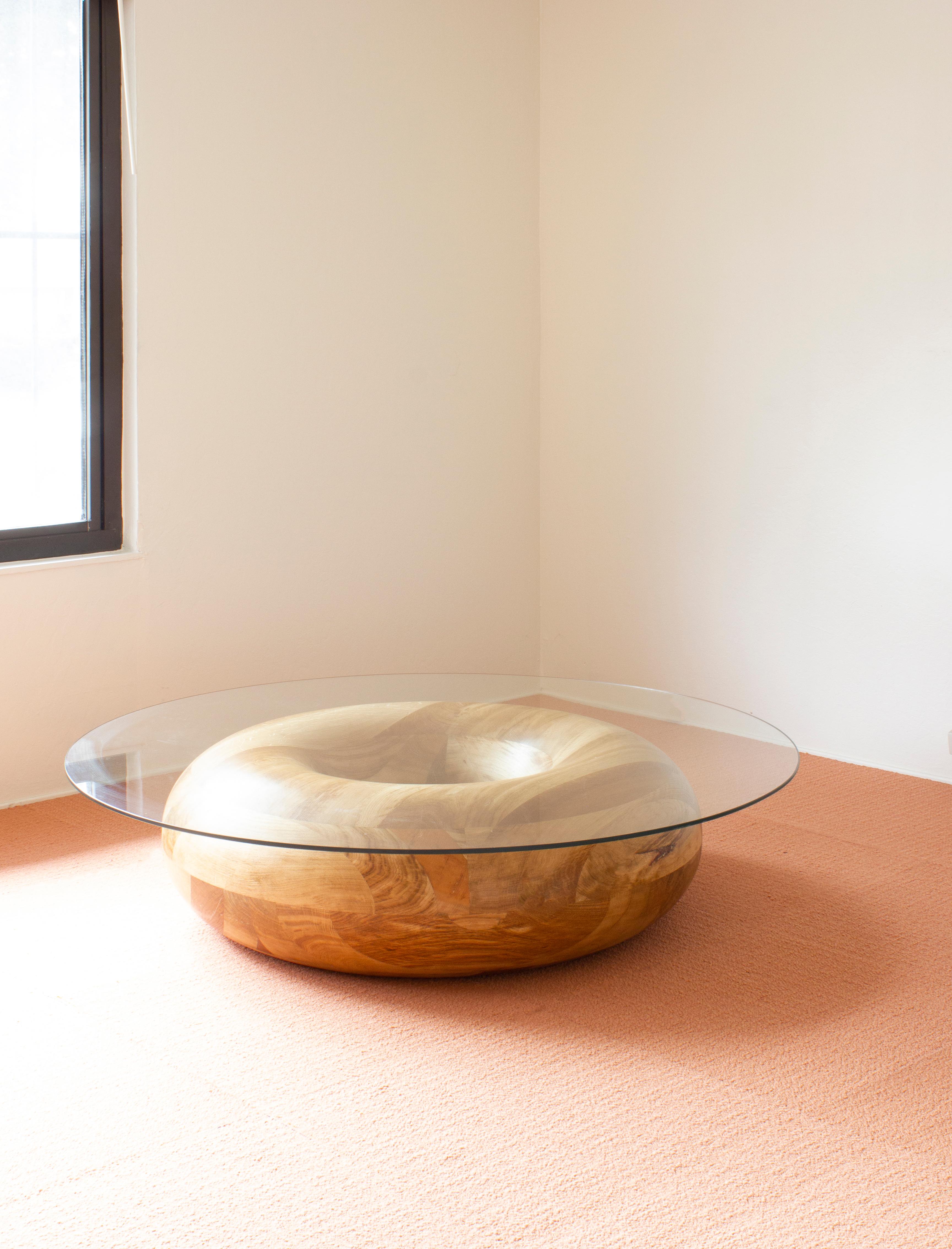 Caramel Donut coffee table by Soft-geometry
Materials: Solid Mango wood coffee table, sugar glaze, glass top
Dimensions: 48 x 48 x 12” H

True to its name, the Donut table is a dense swirl of solid wood, rich with varying grain and gradient.
