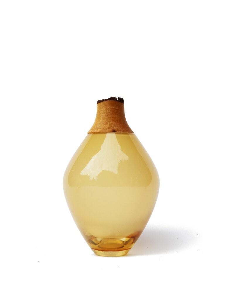 Caramel Matisse stacking vessel III, Pia Wüstenberg.
Dimensions: D 11 x H 21.
Materials: glass, wood.
Available in other colors.

The Matisse Stacking Vessels are treasures, small splashes of curvy glass with a wooden crown. The collection was