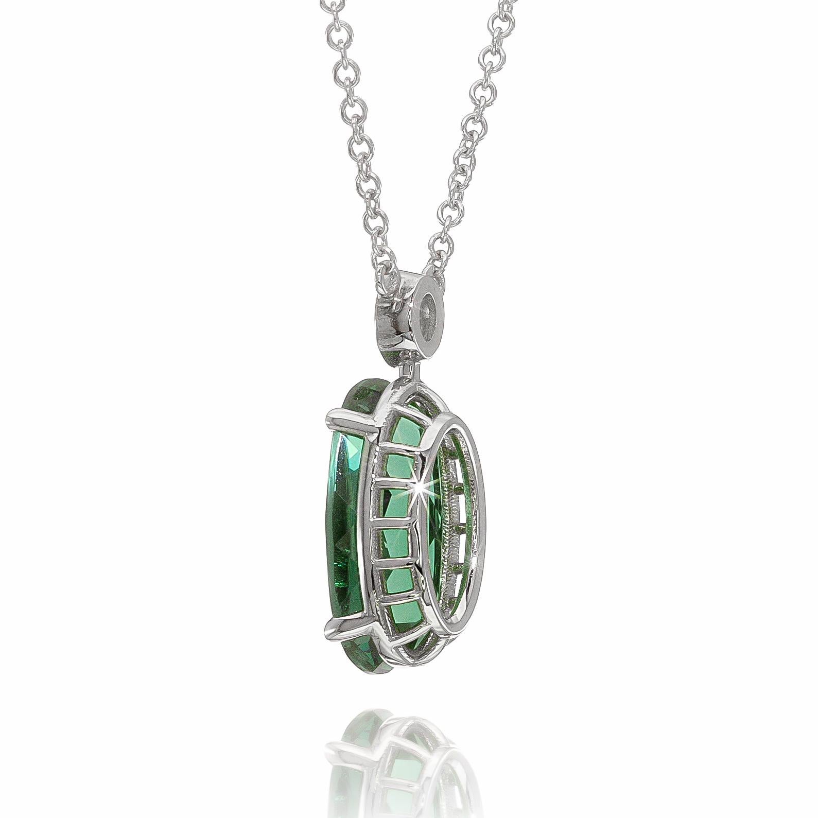 Dive into the captivating allure of this 3.24 carats oval-shaped blue-green Tourmaline pendant set in 14K White Gold. Its mesmerizing color complements a range of skin tones, and the unique mixed cut disperses light beautifully, showcasing its
