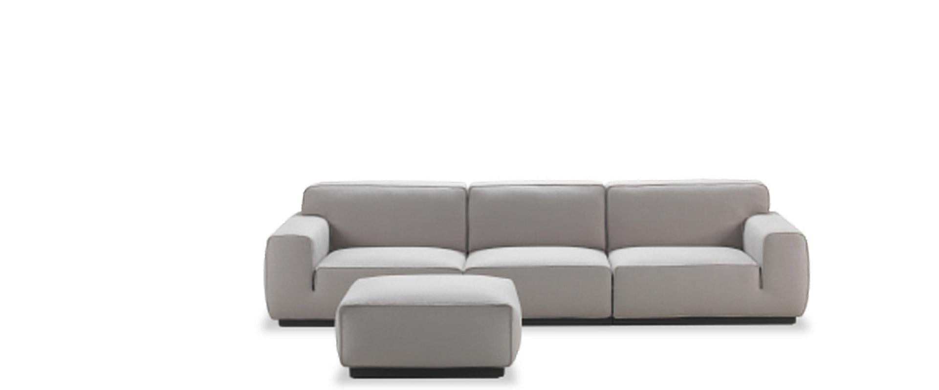 A modular sofa with soft pastel grey padding and neat seam line.