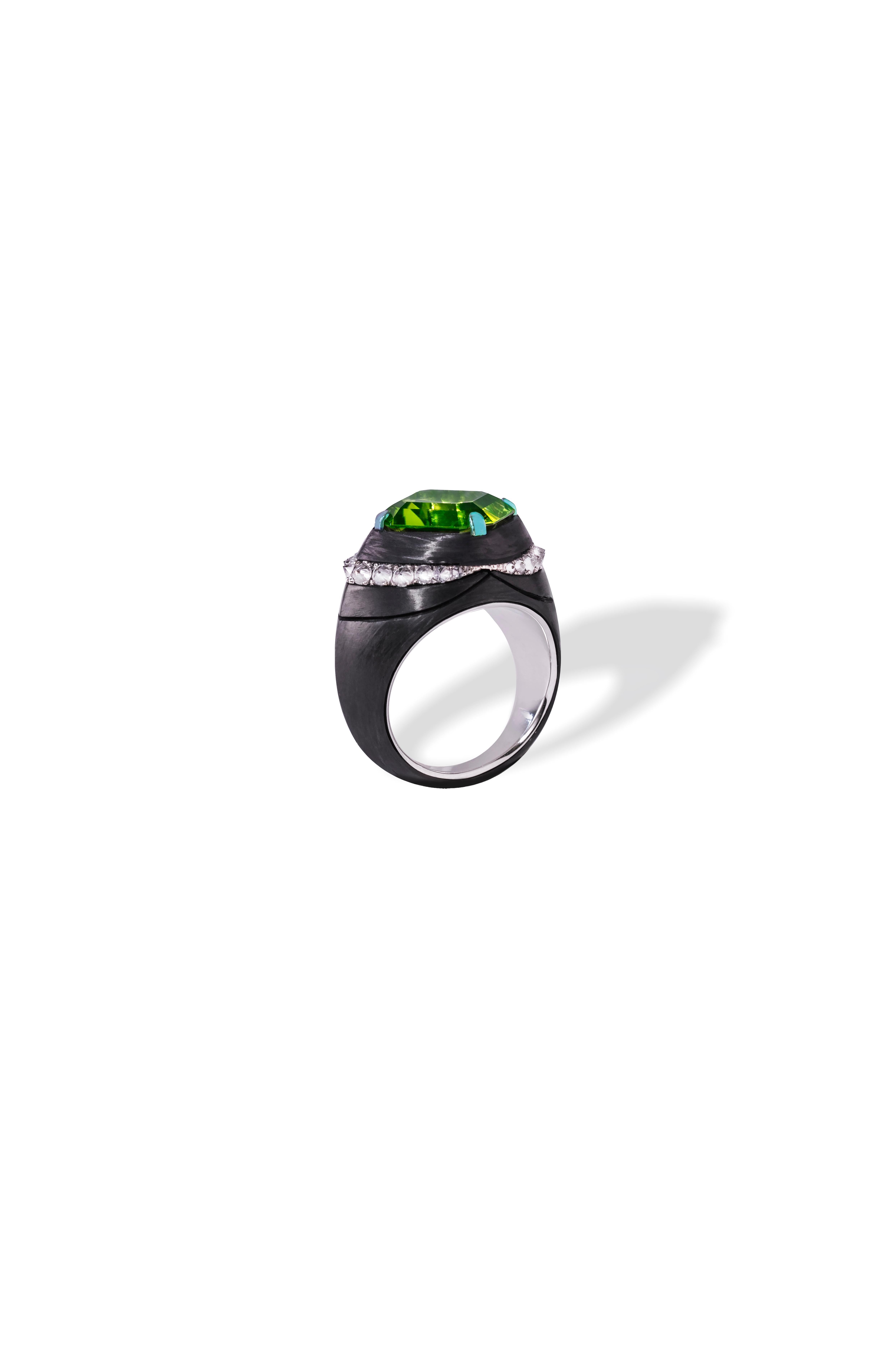 This ring is made to order only. Completely customizable. 
Ring handcrafted in Carbon Fiber,  handset White Diamonds 0,7 ct., 18W gold 8.30 gr., Peridot 7.75 ct. (stone size 12x12x7.18mm). 

Gemstones are natural and not treated. 

Intricate work in