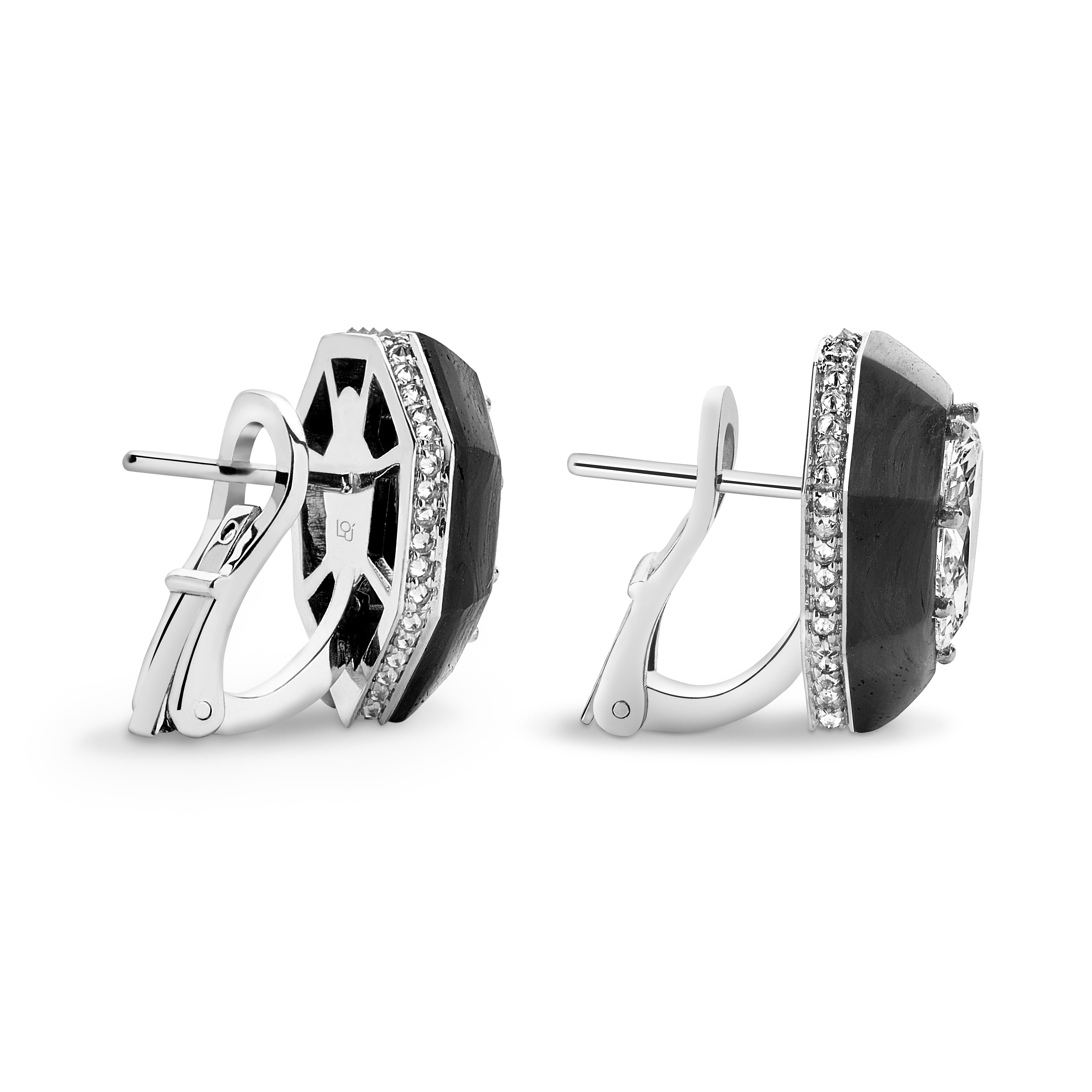 Earrings hand crafted in Carbon Fiber, 18K white gold.

Carat weight (White Diamonds - centre stones): 2.41
Carat weight (White Diamonds - pave): 0.4
Carat total weight: 2.86
Weight of white gold: 6 gr.

Intricate work in carbon fiber is done by