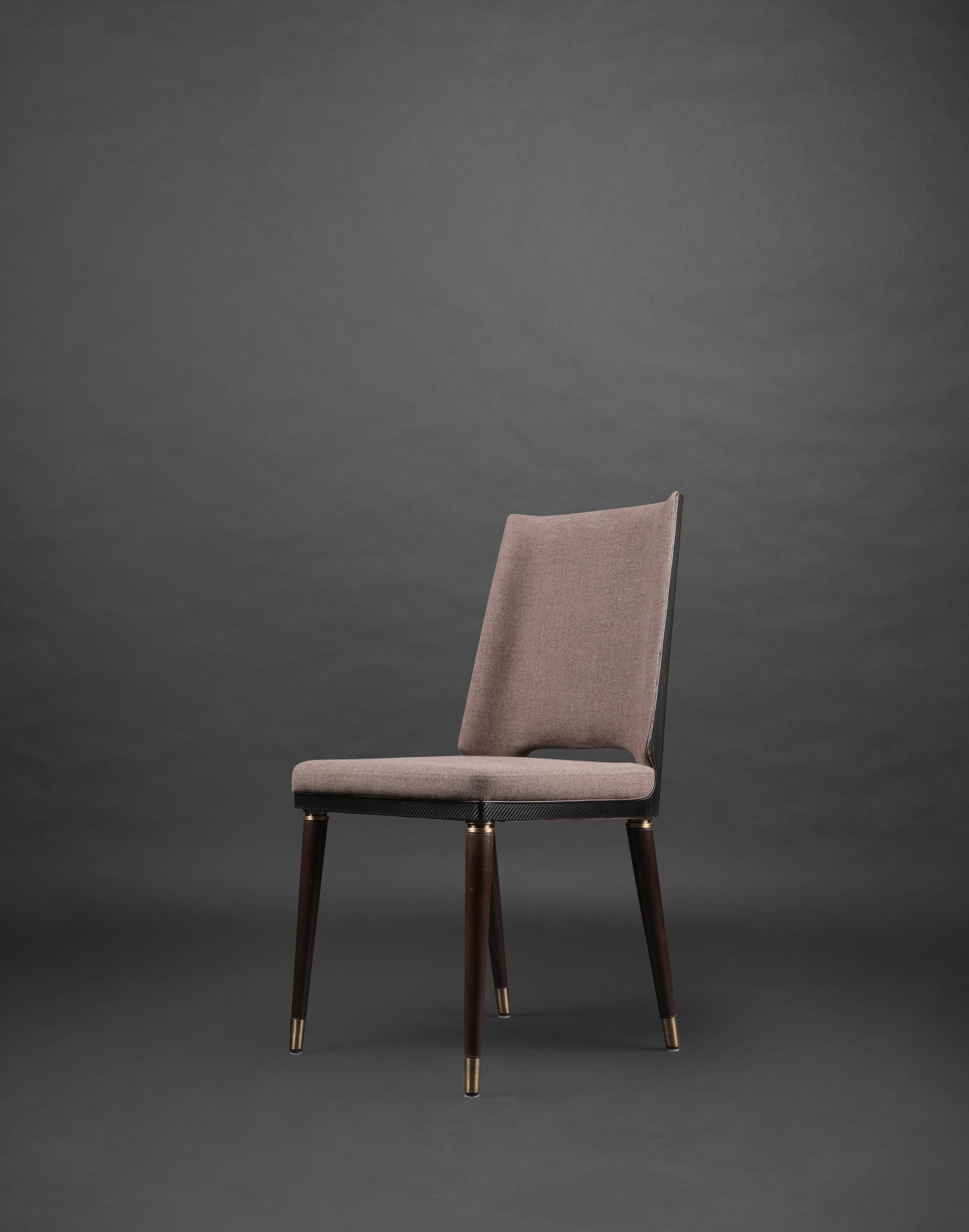 Carbon fibre irving dining chair by Madheke.
Dimensions: W 56 D 51 H 91 cm.
Materials: carbon fibre, metal.

Carbon fibre chair back with upholstered seat. Seamless carbon fibre leg detailed with metal trim.

Reflecting the finest in