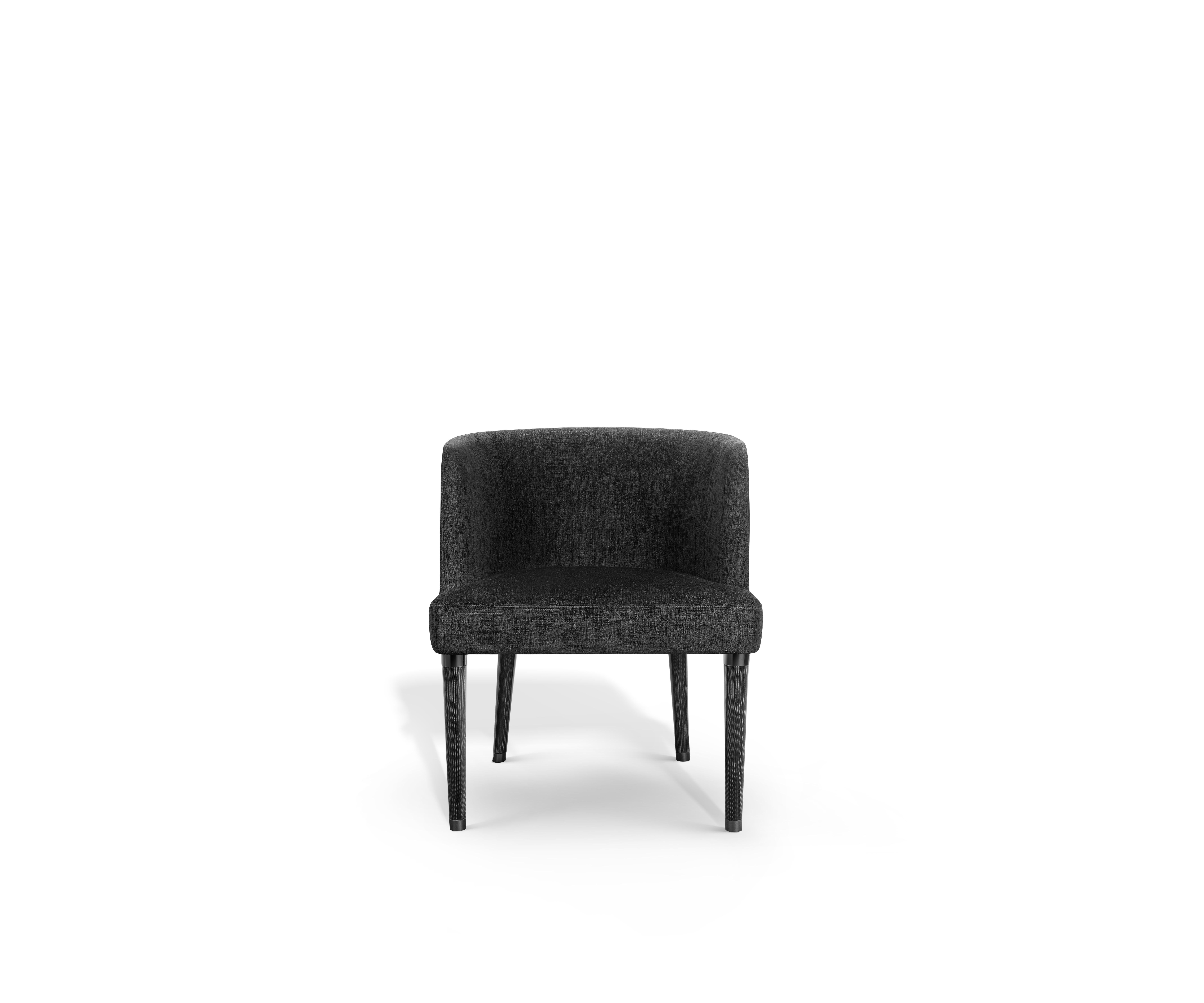 The Norton chair delivers a striking balance of advanced design and sculptural elegance.
Its inviting barrel back, upholstered in velvet, provides a soft, tactile experience, while the exterior shell, crafted from carbon fibre, exudes strength and