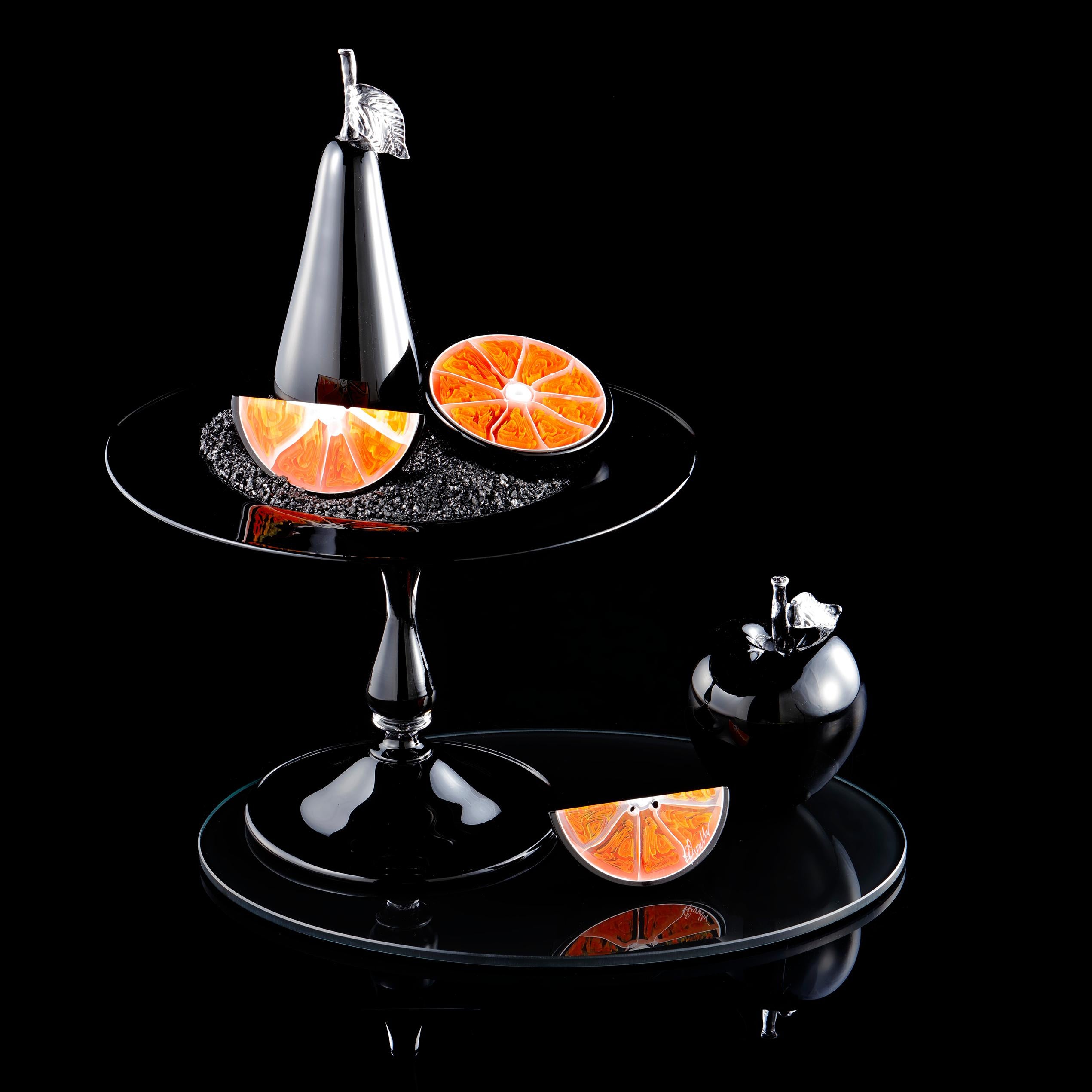 Carbon Orange is one of the British artist Elliot Walker's ongoing body of unique still life artworks. These compositions have the poise of classical paintings. Symbols of domestic life are carefully balanced with the transient. Luscious exotic