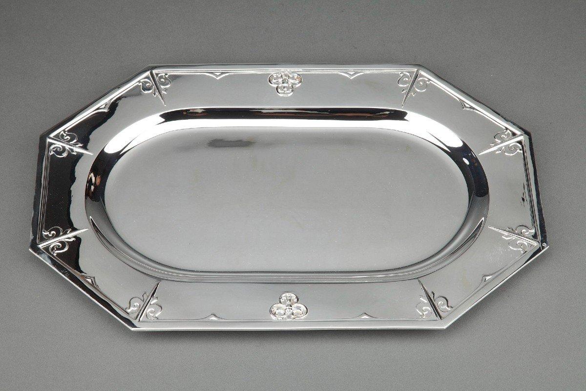 Rectangular octagonal dish in solid silver decorated with a spearhead and two mascaron heads numbered 