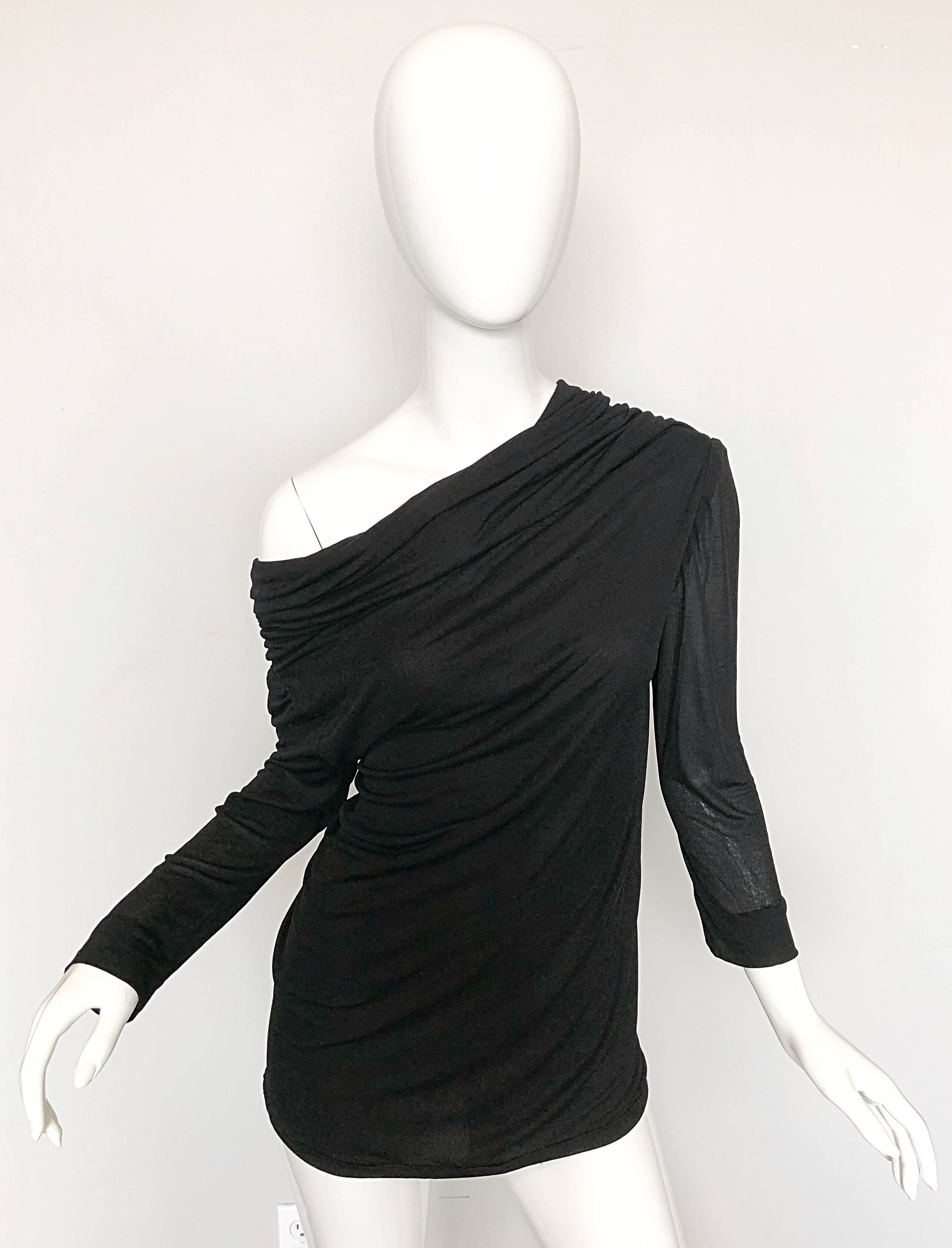 Amazing vintage 70s CARDINALI COUTURE black silk jersey blouse! From the Spring 1972 Runway Collection. This versatile gem can be worm three different ways :
-off-the-shoulder
-one shoulder 
-scoop neck 
Approximately Size Small -
