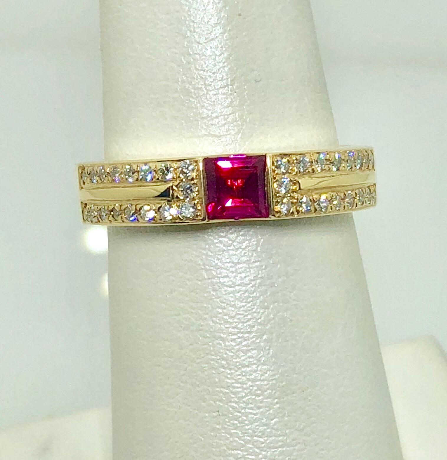 Carelle 18 Karat Yellow Gold Diamond and Ruby Contemporary Ring. This Carelle creation is created in 18 karat yellow gold, weight- 8.0 grams. This contemporary style ring is adorned with 34 flush set  round diamonds and one flush set partial bezel,
