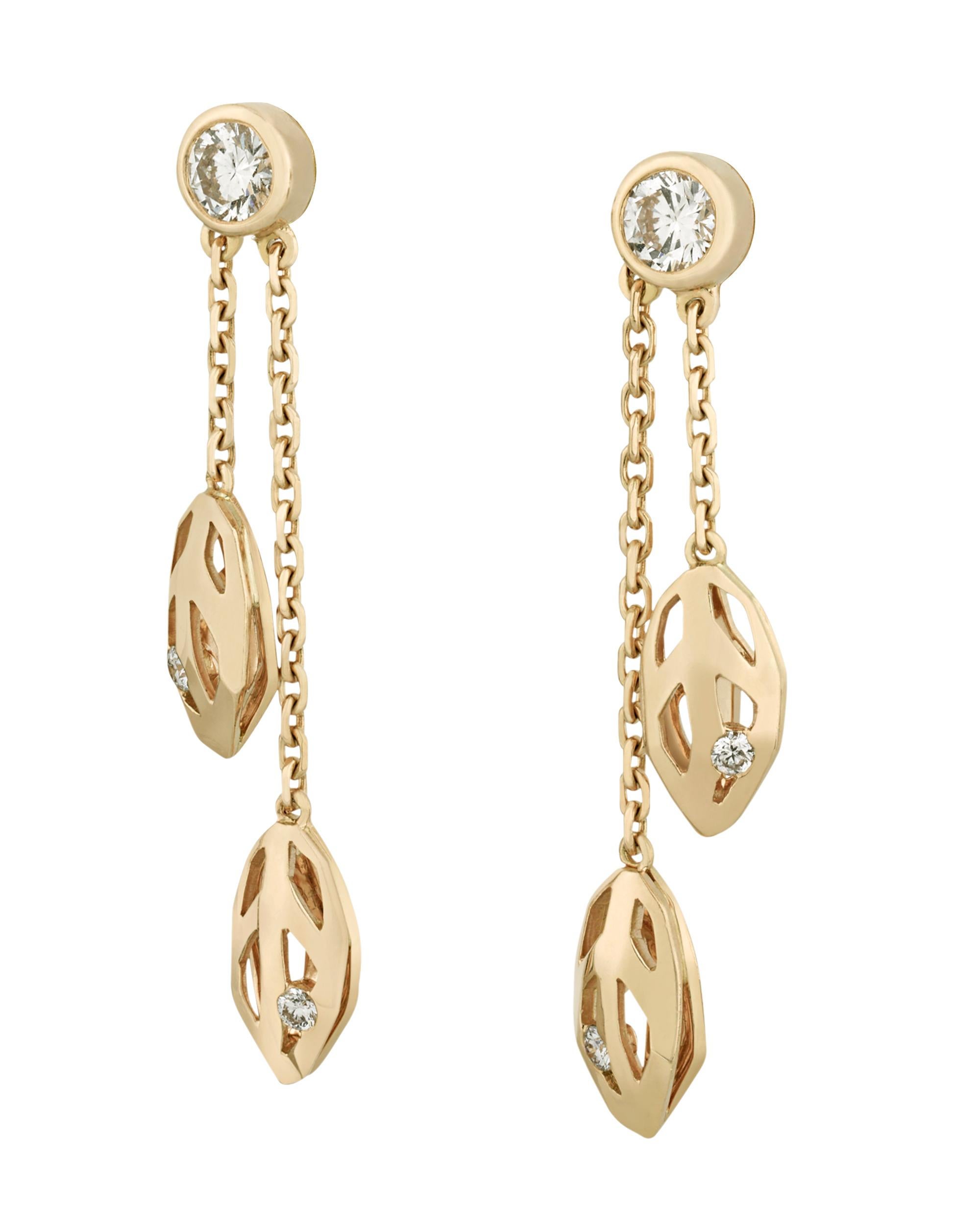 Inspired by the graceful beauty of an orchid, these earrings from Cartier's Caresse d'Orchidées collection are a brilliant example of the firm's creative genius. Crafted of 18K yellow gold, delicate foliate forms hang from white diamond studs adding