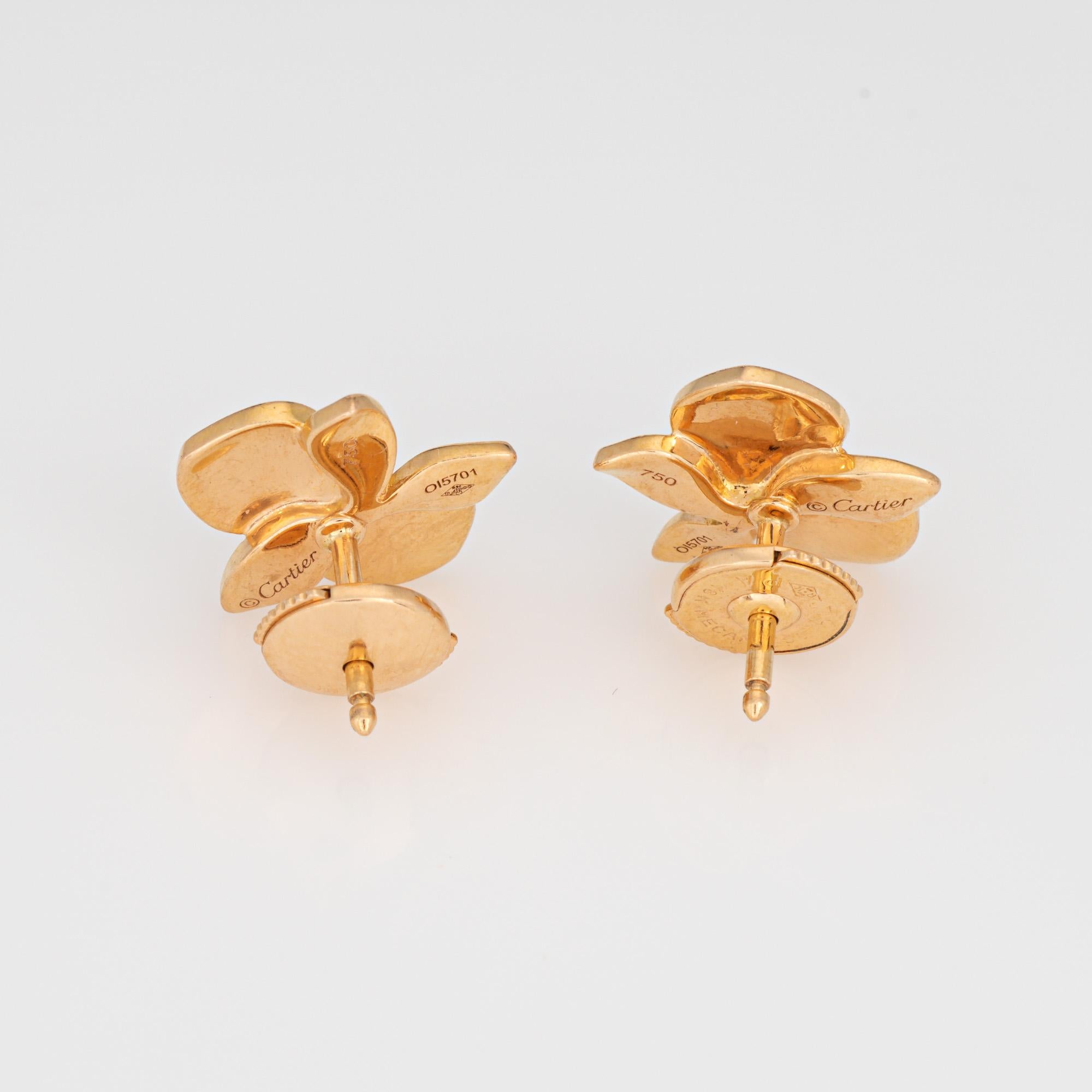 Estate Cartier 'Caresse D'Orchidees' earrings crafted in 18 karat yellow gold.  

2 round brilliant cut diamonds total an estimated 0.02 carats (estimated at F-G color and VVS2 clarity). 

The out of production earrings are a Cartier favorite, with