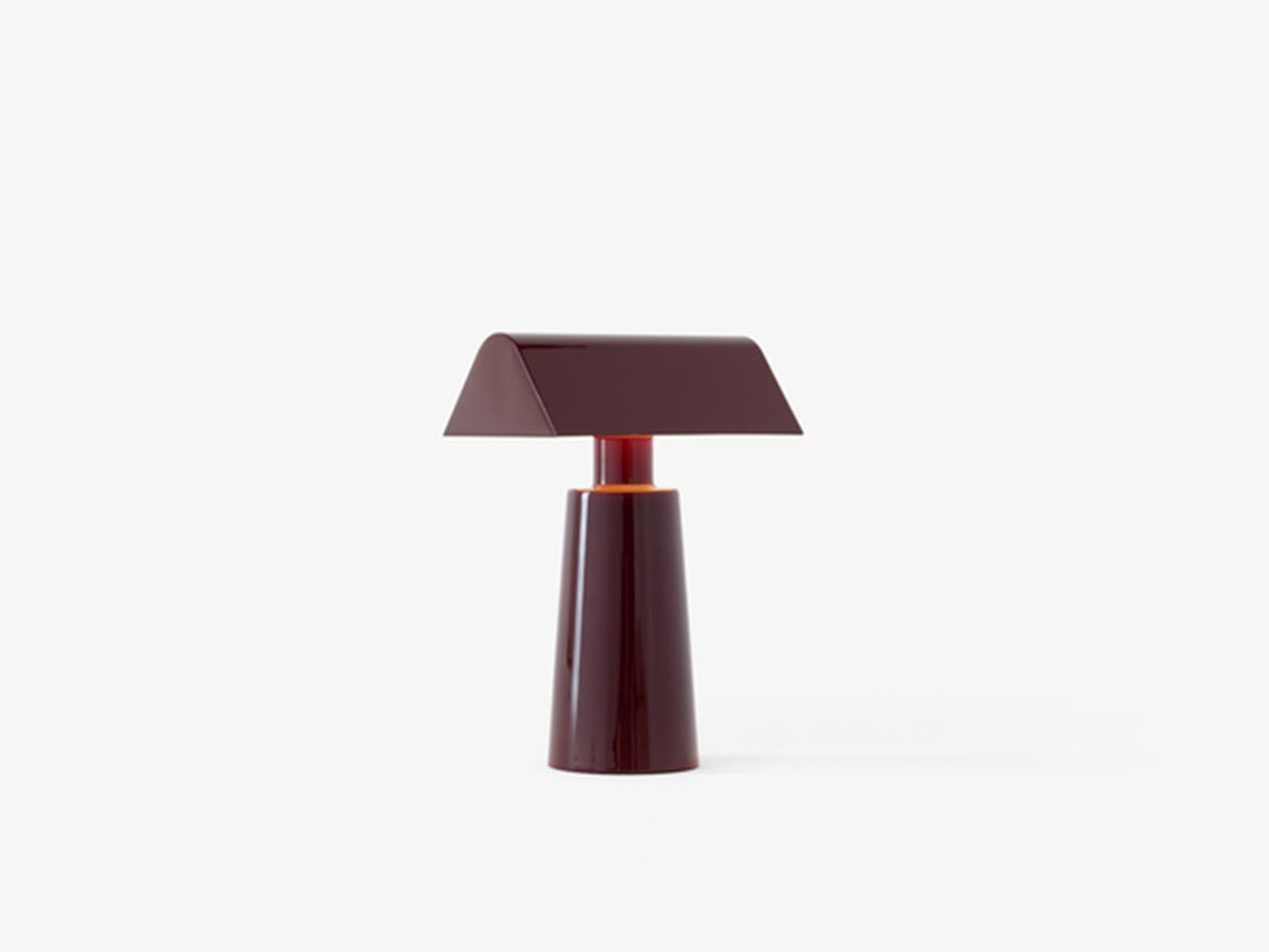 A practical solution to the increasingly blurred boundaries between work and home, the portable Caret reimagines the linear silhouettes of the classic, green-shaded designs – known as 'bankers lamps' – found in historic libraries. 
Made entirely