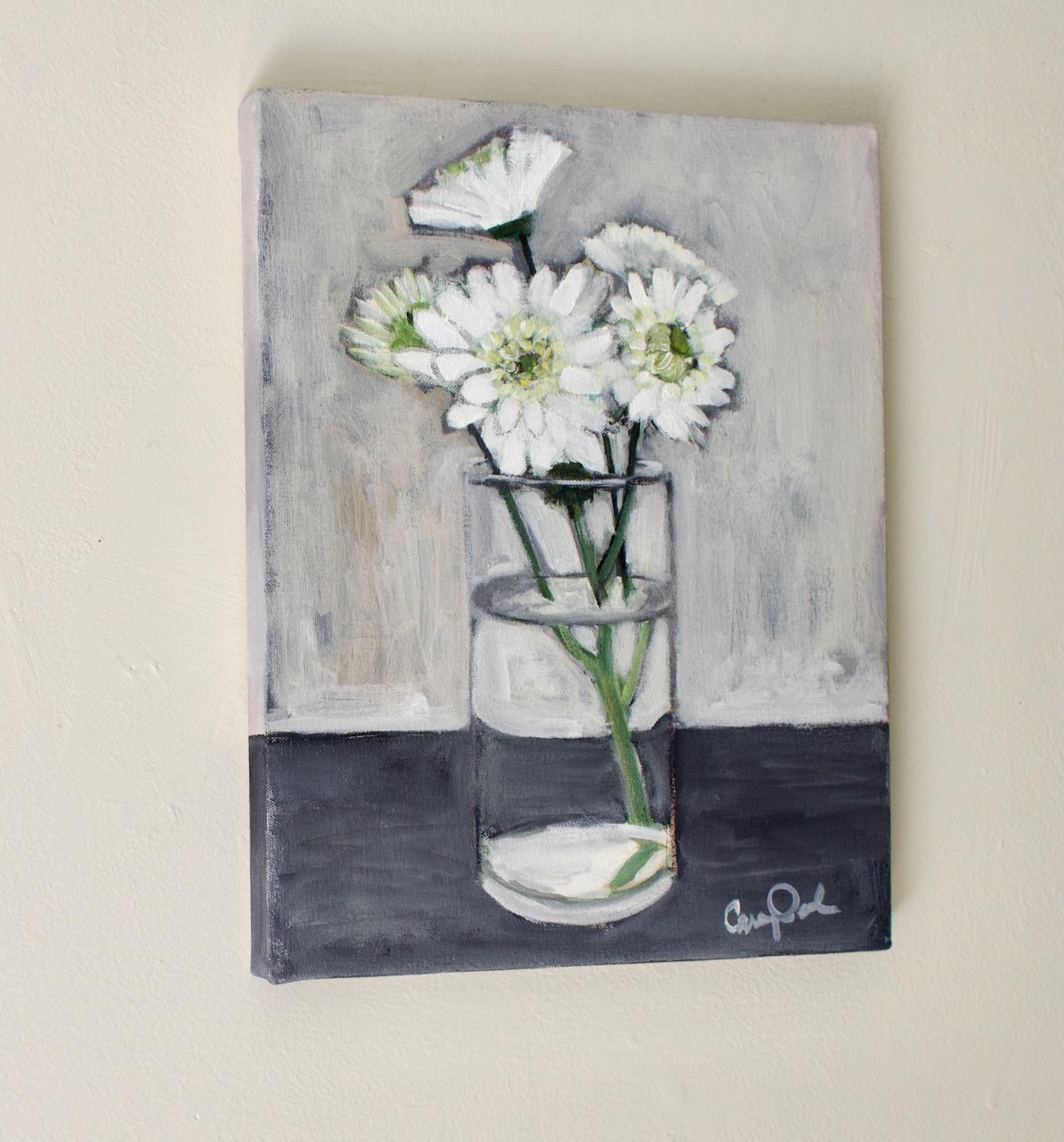 <p>Artist Comments<br />A glass vase holds a bouquet of white flowers, their petals standing out against the gray backdrop. The water distorts the stems, adding an intriguing effect. The nearly monochromatic palette creates a calming atmosphere