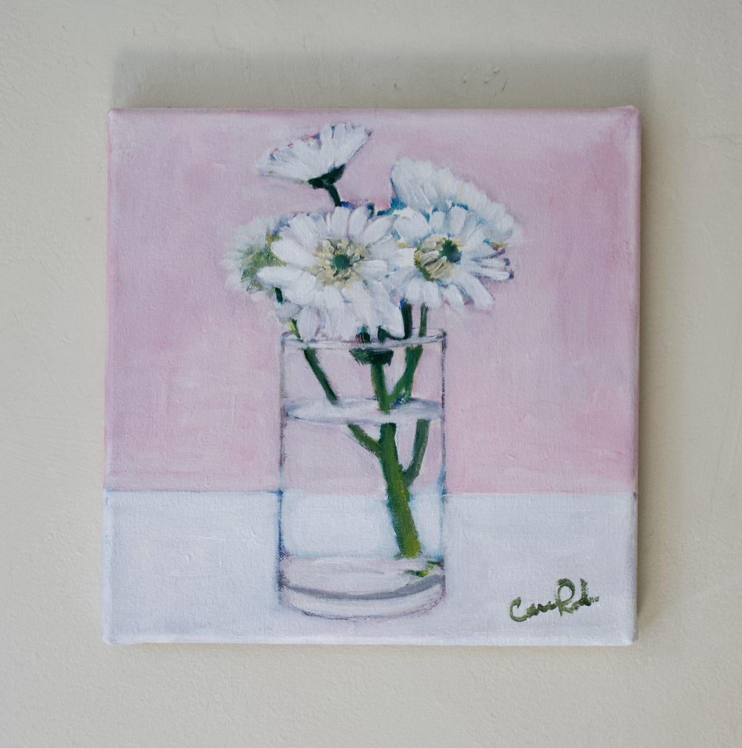 <p>Artist Comments<br>Artist Carey Parks paints delicate white flowers in a pristine glass vase. Resting atop a chalk-colored table, the flowers harmoniously complement the soft pink background. This simple yet elegant composition exudes purity and
