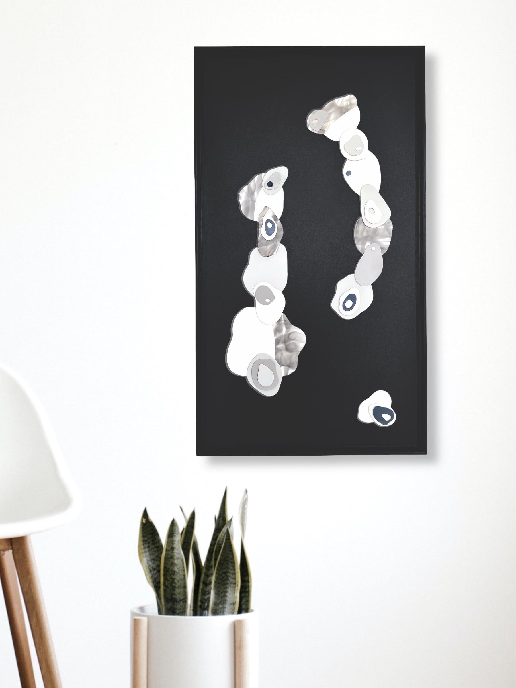 Clouds I . 2022 
Mixed Media abstract, minimalistic, 3D painting on wood panel mounted on a deep floater black frame37H x 21W x 2D  
It is a 3D painting, composed of small pieces of plaster painted with neutral colors as well as smoke. The plaster