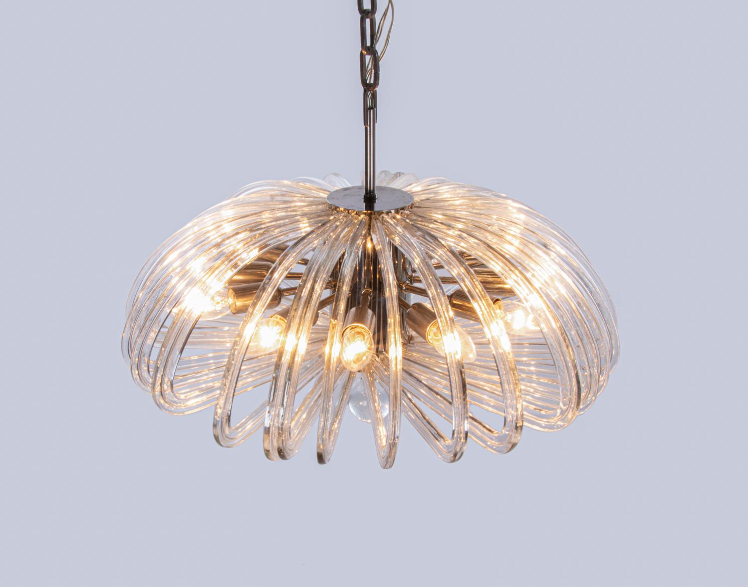 Elegant, wave-shaped chandelier with an incomparable, unique character thanks to its nickel base and curved arms made of clear crystal glass. Has 12 sockets. In very good condition. Chandelier illuminates beautifully and offers a lot of light. Gem