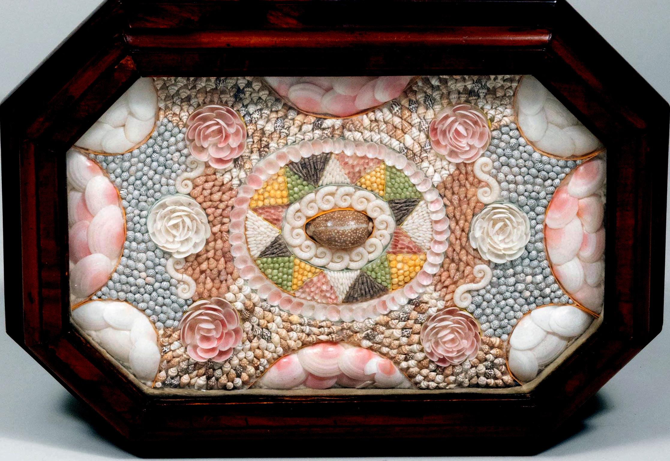 Caribbean mahogany table with sailor's valentine top,
circa 1840


The Victorian mahogany table with a central column with a shaped square footed base. It has a shaped top containing a valentine of seashells below a hinged top with a glass