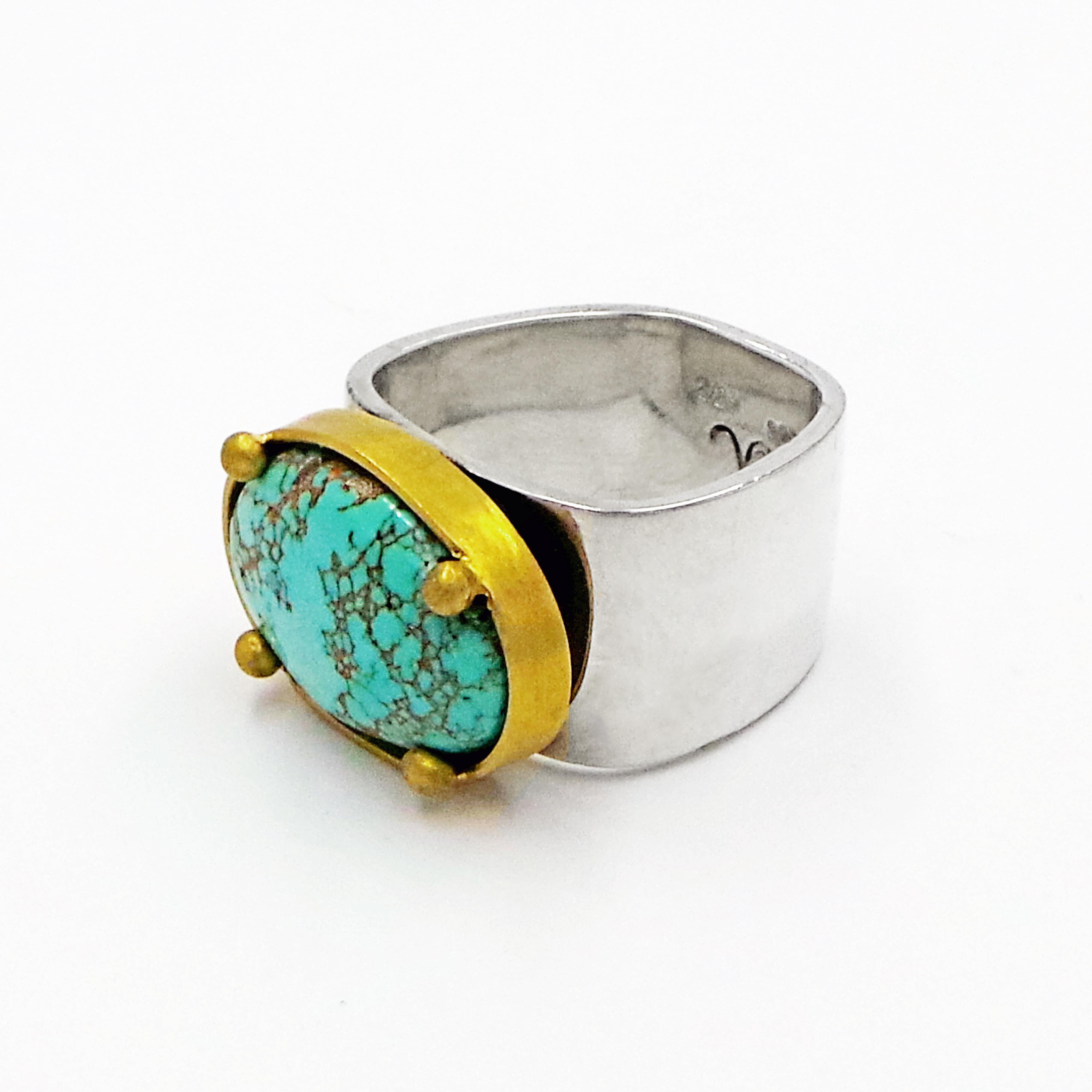 Stunning, blue-green Carico Lake Turquoise (Nevada, USA) set in textured 22k yellow gold bezel with prongs fixed to a sterling silver square shaped band. Ring is size 7. Gemstone's dimensions are 0.75x0.5 inches or 19x13mm. Band is 0.5 inches or