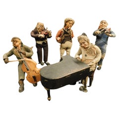 Glockenspiel mit fünf Lappenmusikern, Stoffkörper, Eisenfüße, Kopf aus Pappmaché, Italien