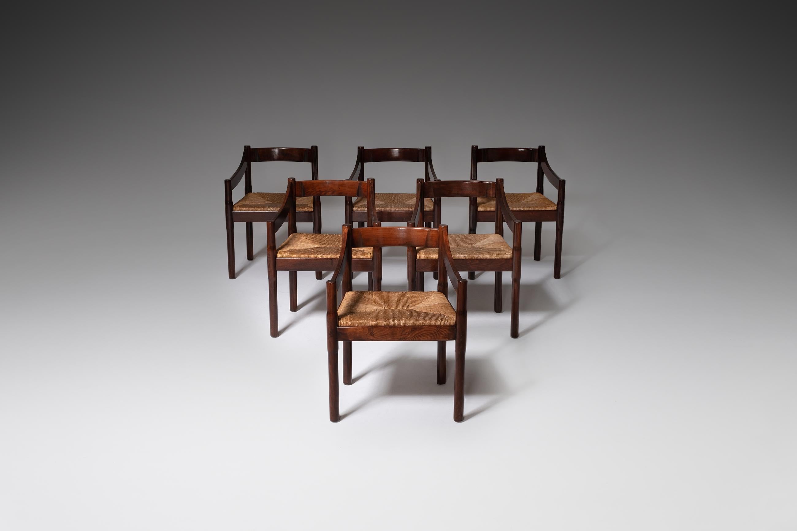 Set of six ‘Carimate’ dining chairs by Vico Magistretti for Cassina, Italy, 1962. The beautiful combination of natural materials such as the stained walnut and rush seatings give these chairs an elegant and warm look. The chairs where originally