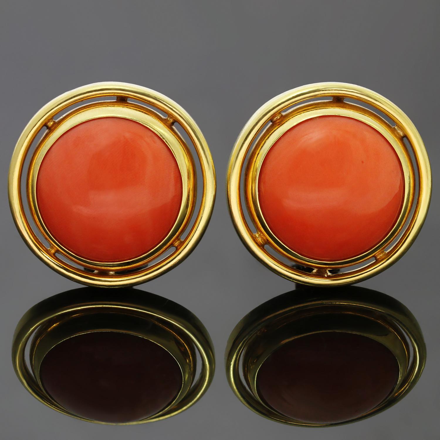 These stunning large round earrings are crafted in 18k yellow gold and feature beautiful even color cabochon red corals measuring 18.40mm x 11.30mm and 18.15mm x 10.85mm. These lever-back clip-on earrings are made for non-pierced ears and we can add