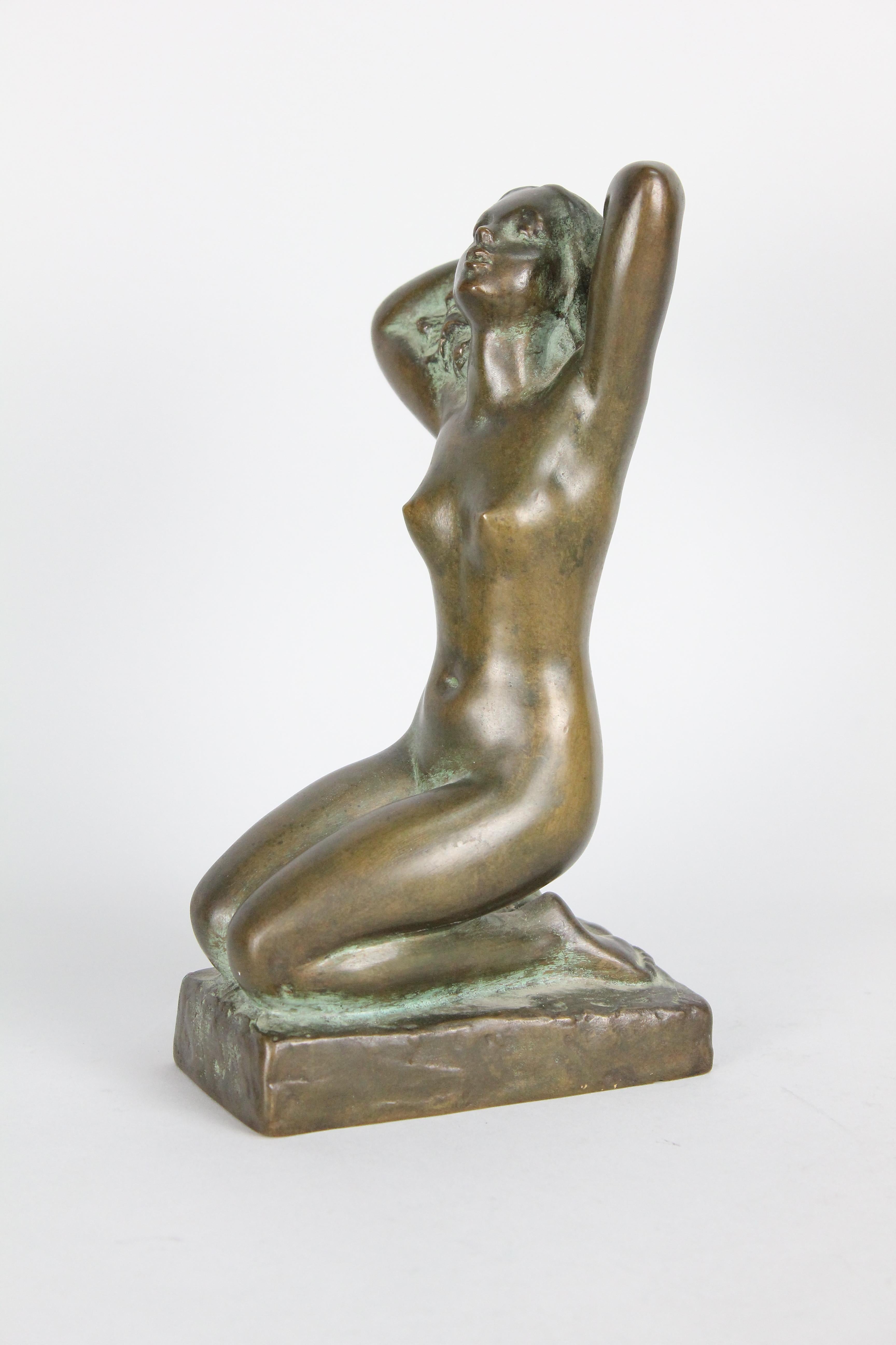 Very nice bronze sculpture of a nude girl with her arms over her head.
It is signed 