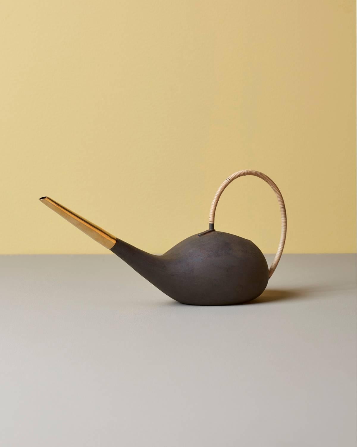 Patinated watering can #3632 by Carl Auböck in brass and cane.


