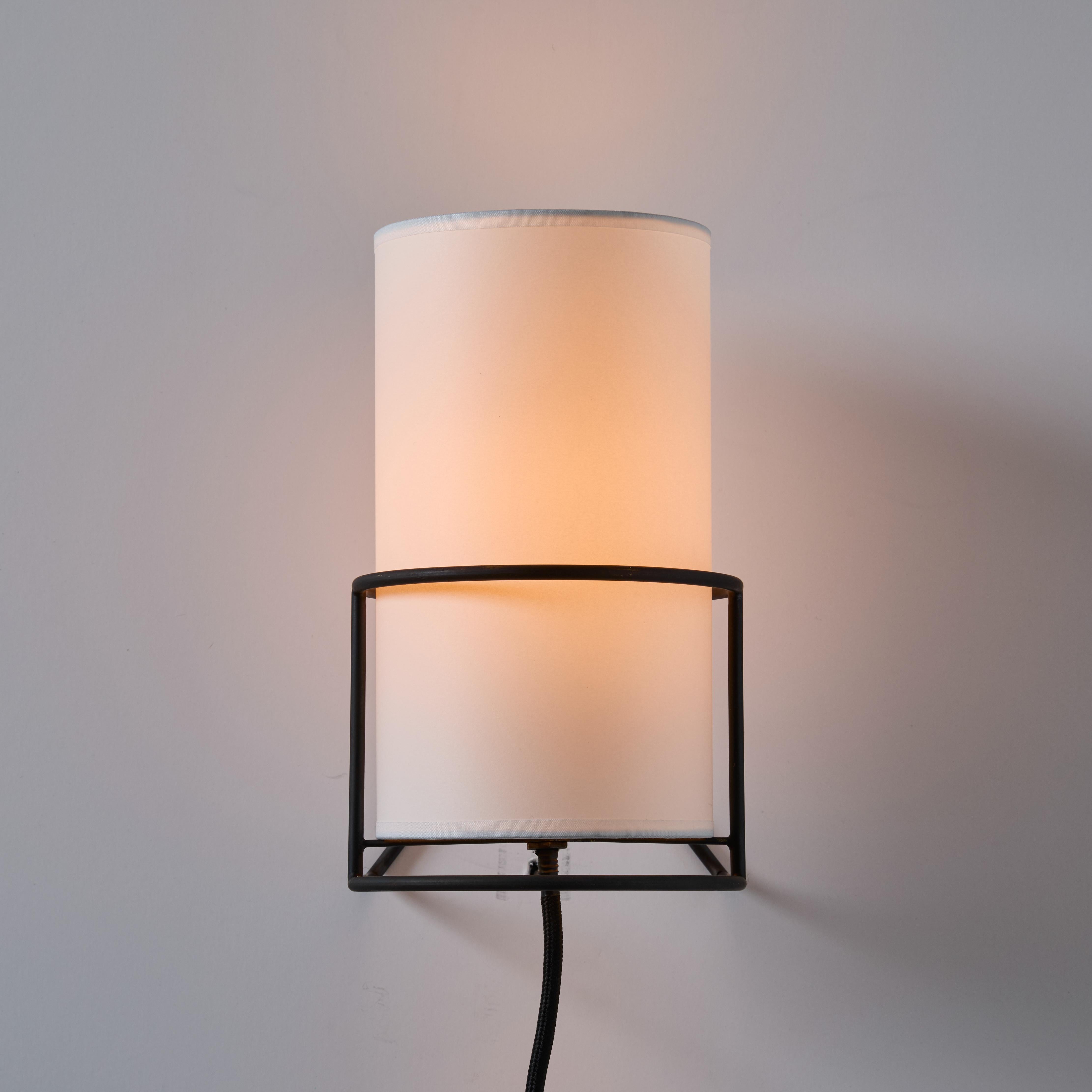 Carl Auböck '4723' Patinated Brass Plug-In Wall Light With White Shade.

Designed in 1950, this versatile and minimalist Viennese lamp is executed in brass with a cast iron base and sculptural hard paper shade by Werkstätte Carl Auböck in Austria.