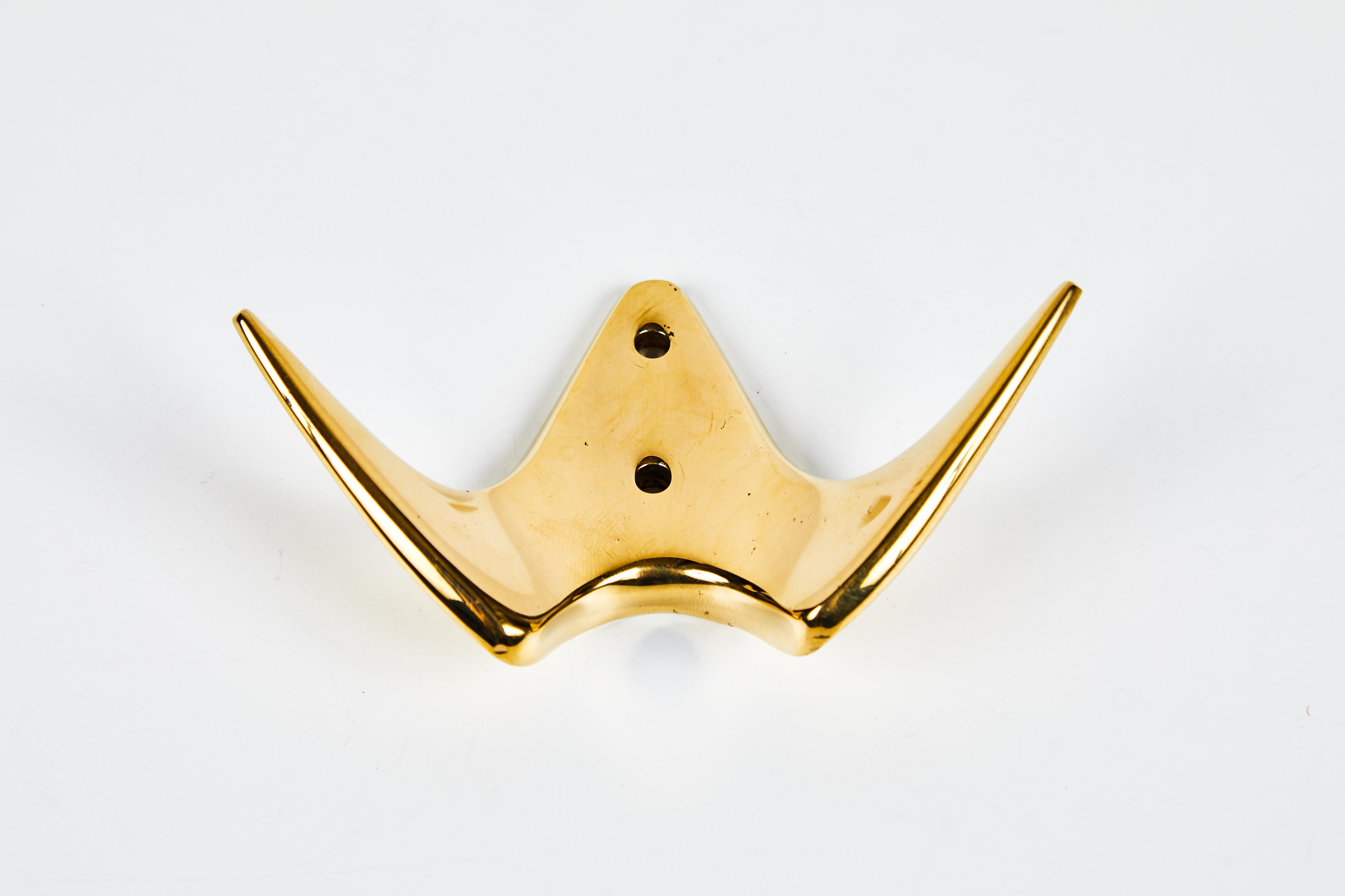 Carl Auböck brass #4995 brass hook. Designed in the 1950s, this versatile and Minimalist Viennese candleholder is executed in polished and patinated brass by Werkstätte Carl Auböck, Austria. 

Price is per item. 2 in stock. Out of stock lead time