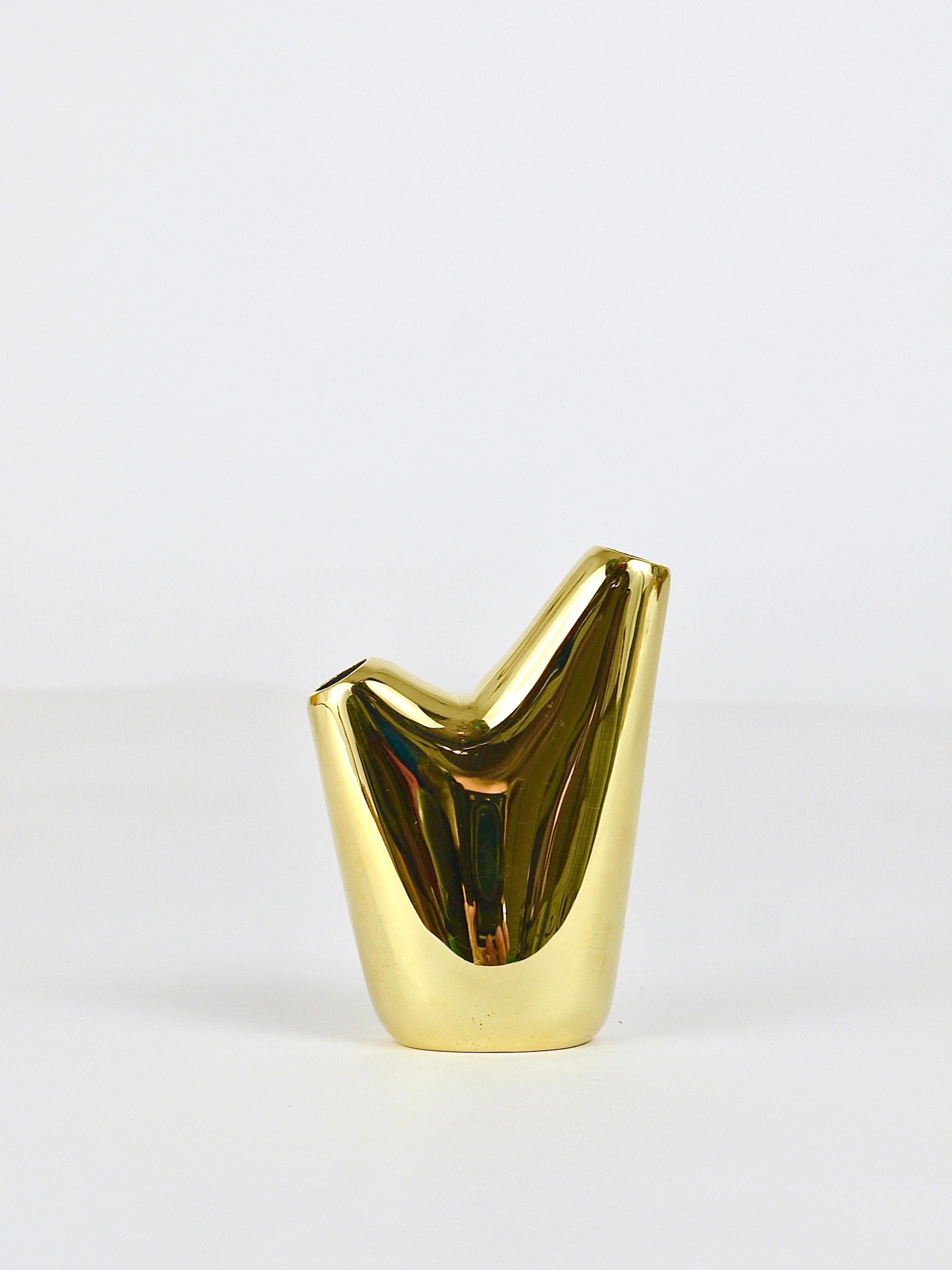 A beautiful organic flower vase, model #3974, designed by Carl Aubock II in 1950. Executed by Werkstätte Auböck in Vienna / Austria. Handmade of brass, this is the fully mirror-polished version, not the more common black patinated one. Fully marked.
