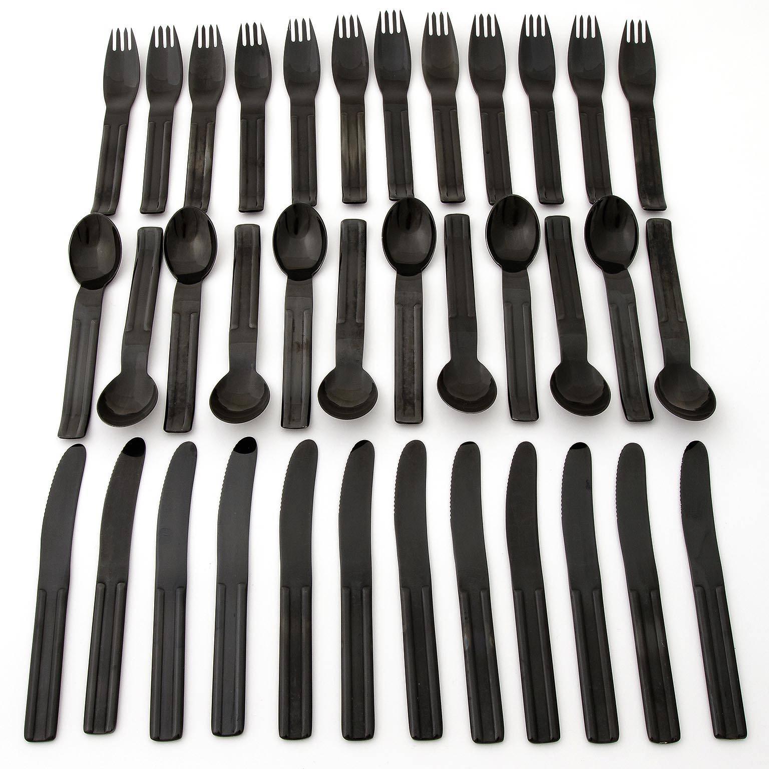 A gorgeous set of a black flatware / cutlery from the Culinar-series for 12 people designed by Carl Auboeck for Ostovics, manufactured by Collini Austria, circa 1980. It is made of blackened stainless steel.
Each piece is marked on the back with