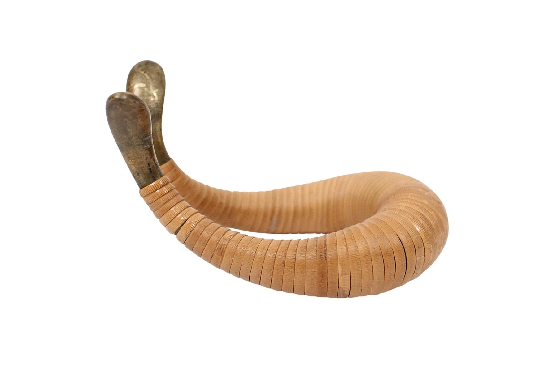 Cane wrapped brass pipe rest by Austrian master object designer Carl Auböck. This example with excellent original age and patina. Designed as a pipe rest but perfect for the artful display of jewelry or watches as well. Impressed mark 