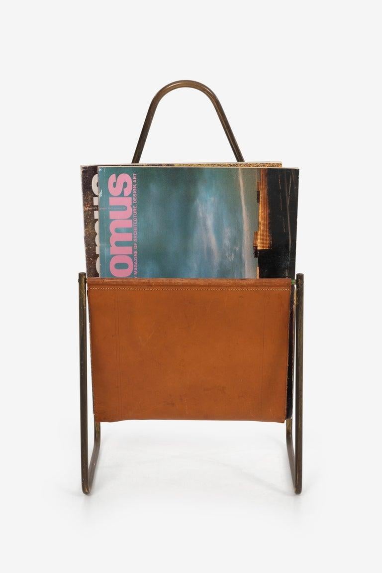 Carl Auböck brass and leather magazine rack, patined cognac leather and brass, model 3808
Note; strong patina and wear with several tears on edges and underside, consistent with age and use, presents well.
Signed with impressed distributor's mark