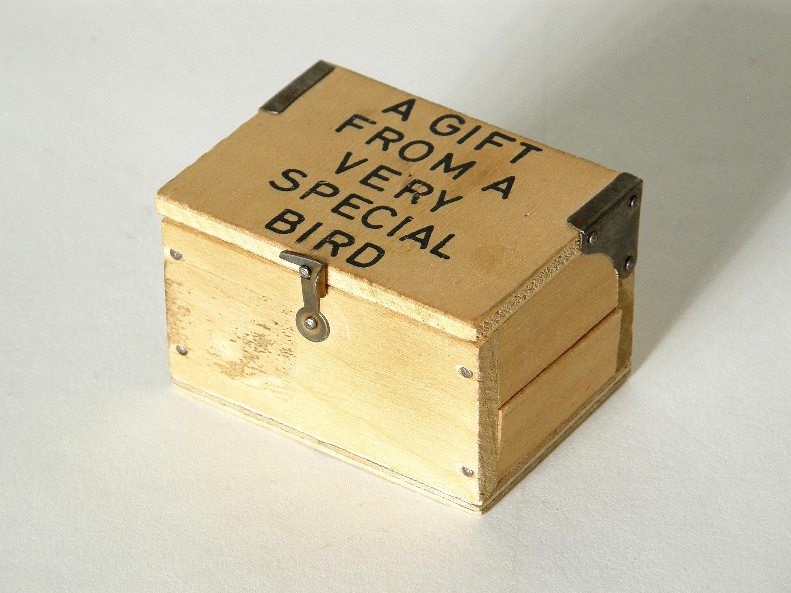 This brass paperweight shaped like a bird egg is from the Carl Auböck workshop in Vienna. It comes in its original box that is a little wooden crate with a hinged lid. On the lid is stamped 