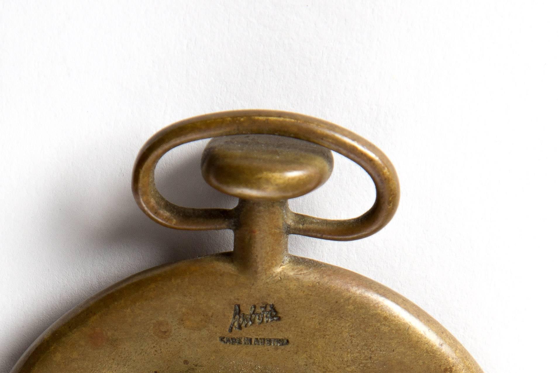 Carl Auböck. Brass opener as a pocket watch. Market on the back. Heavy piece. Can also be used as a paperweight.