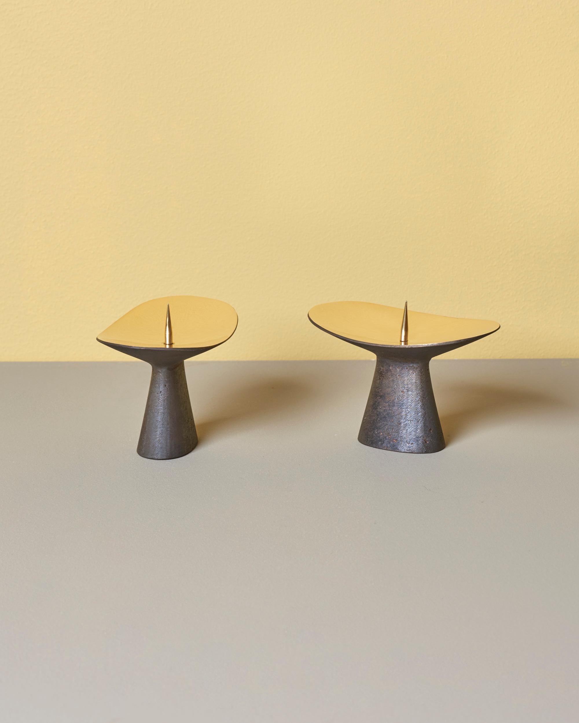Carl Auböck candleholders with patinated brass base and polished top.
 
  