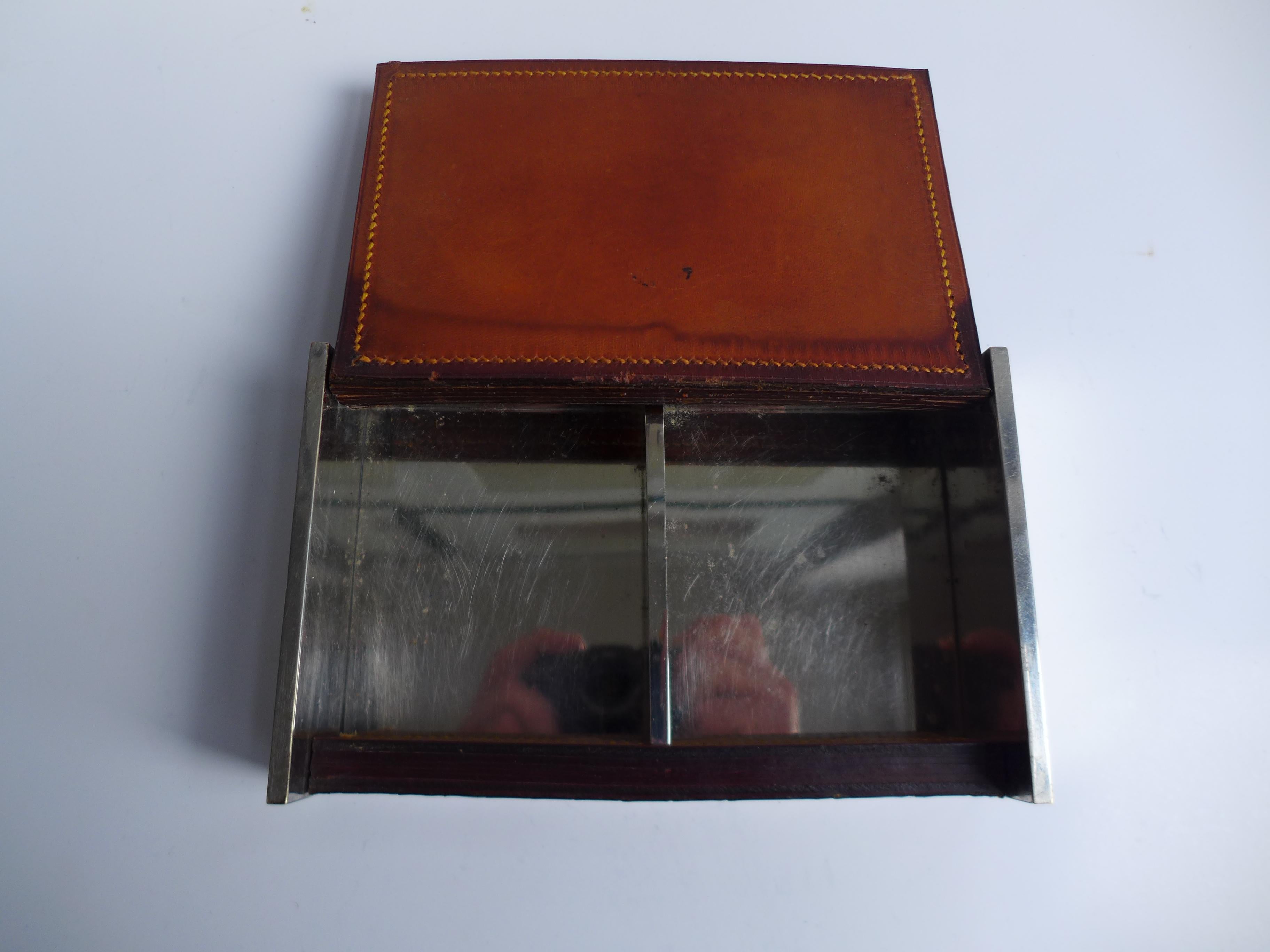 A refined early piece from the Carl Auböck workshop, dating to the 1930s. This chrome-plated box features clean, modernist lines contrasted by a hand-stitched leather lid — a hallmark of Auböck’s craftsmanship in the interwar period. Functional yet