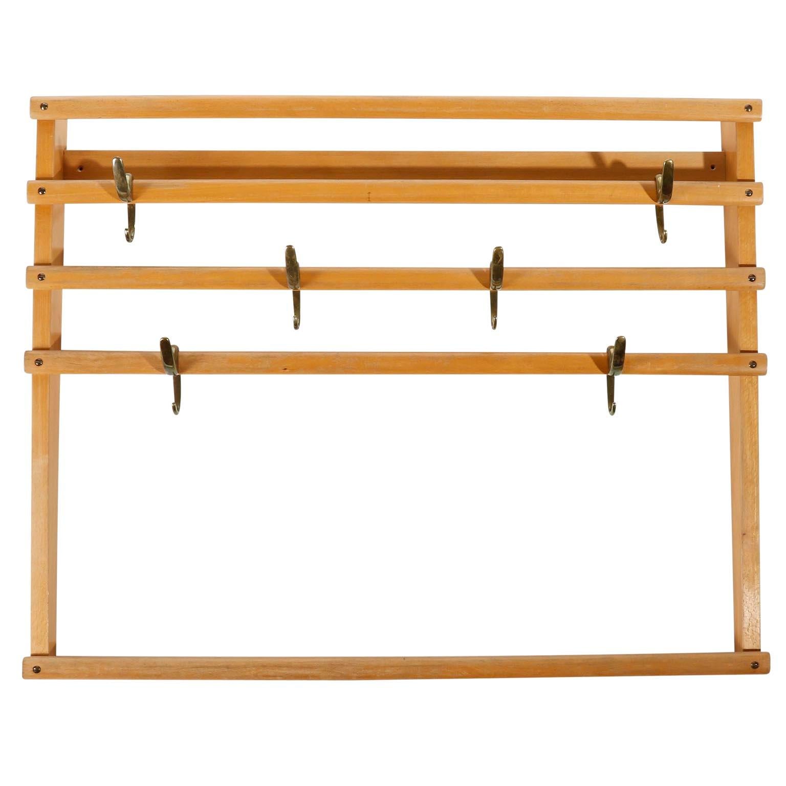 A coat rack by Carl Auböck, Vienna, Austria, manufactured in midcentury, circa 1950.
It is made of a beechwood frame in an aged and very warm tone. There are six patinated brass hooks (similar to bronze) which can be positioned randomly on the