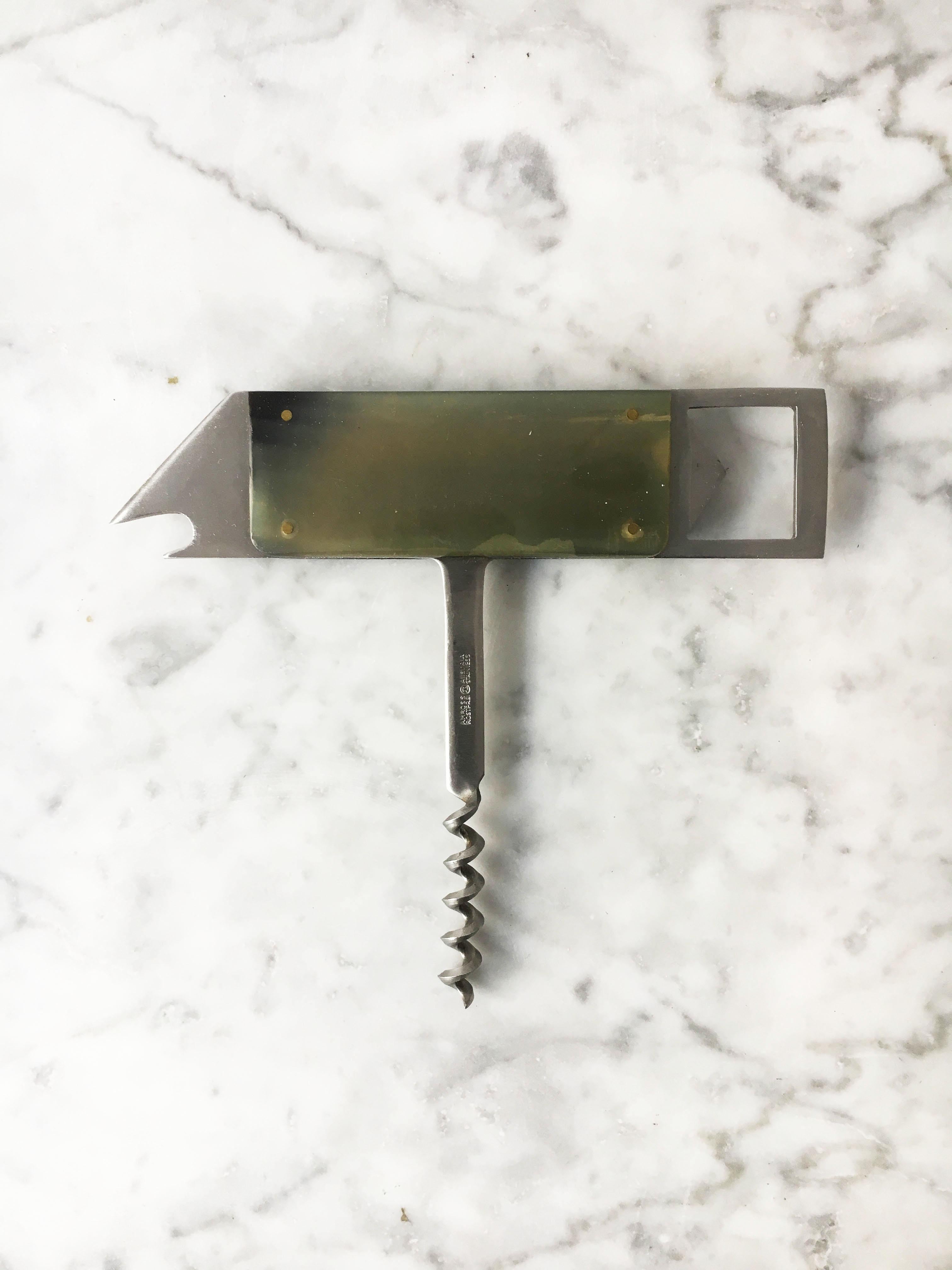A beautiful abstract fish shaped bottle opener cork screw design object by Carl Auböck. The minimalist sculptural shape is made in stainless steel covered in horn plates. In excellent condition with just the right amount of lovely gently aged patina.