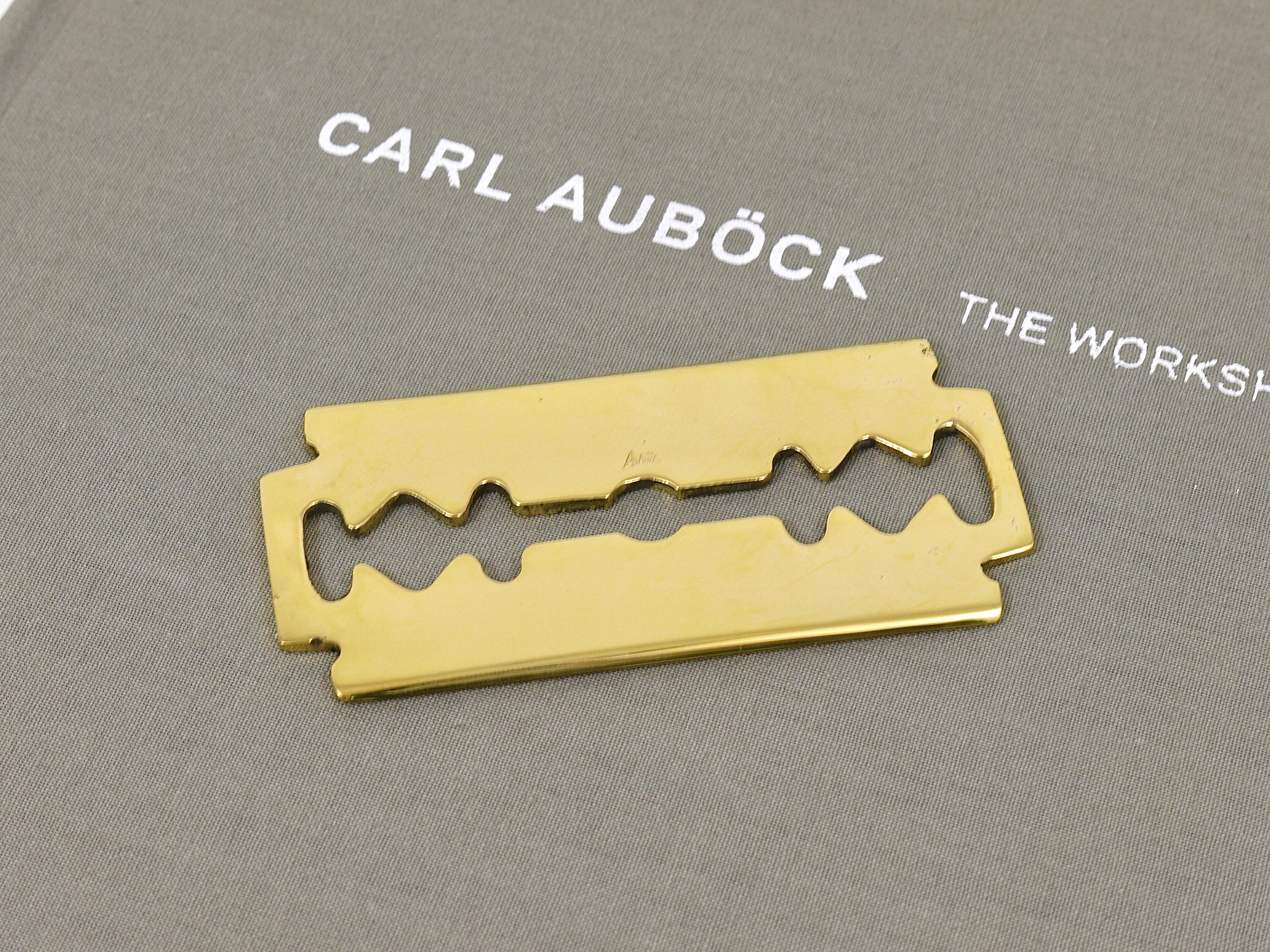 A handmade paperweight in the shape of a razorblade, model 5378, originally designed by Carl Aubock in the 1950s. A very charming piece, reissued by Werkstätte Auböck in Vienna / Austria. Handmade of polished brass. Marked. A decorative object on