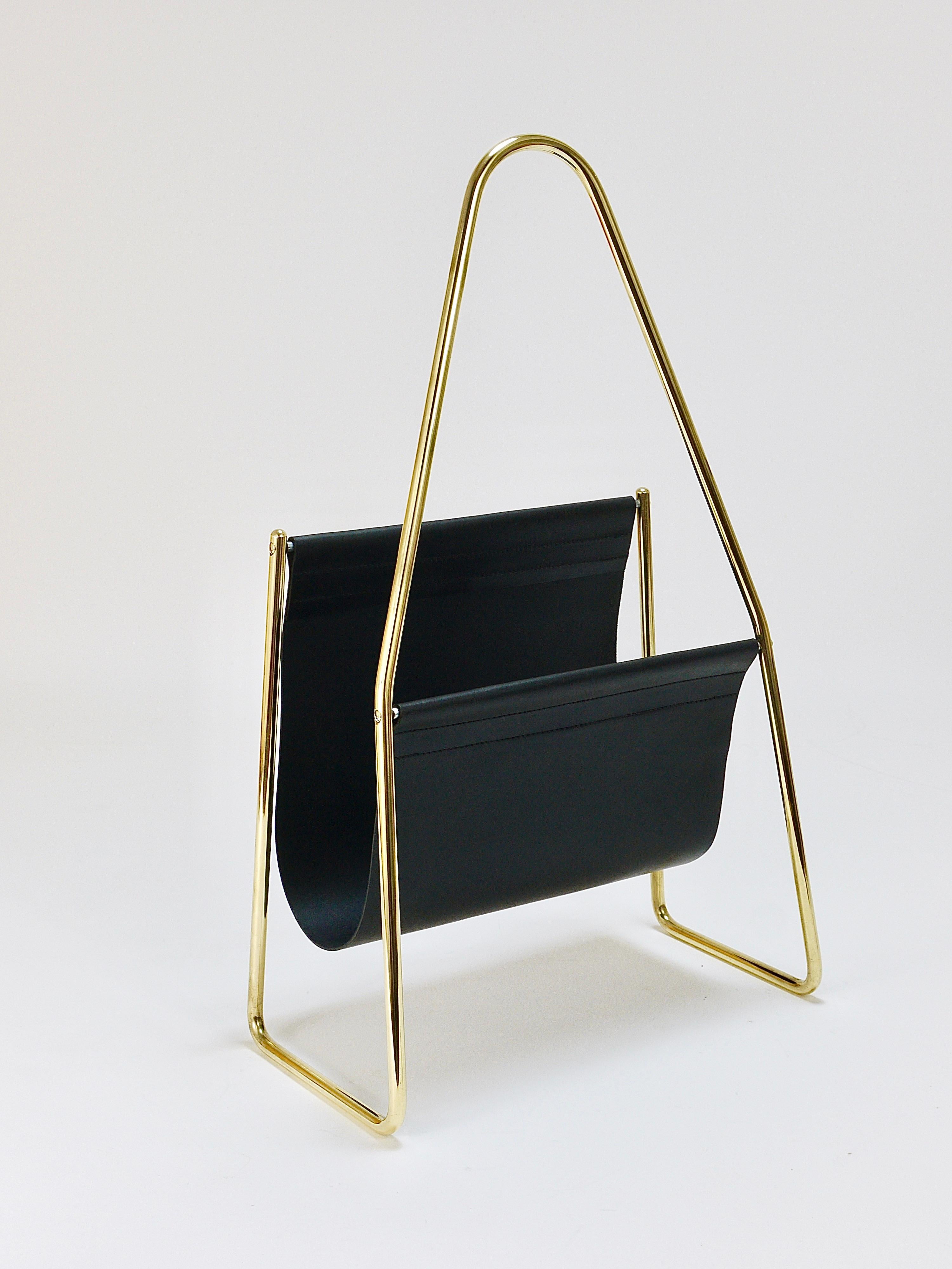 A beautiful modernist original and old newspaper stand / magazine rack from the 1950s. Model No. 3808. Designed and manufactured by Carl Auböck, Austria. The news rack is in very good condition, its solid brass frame has been polished by hand, the