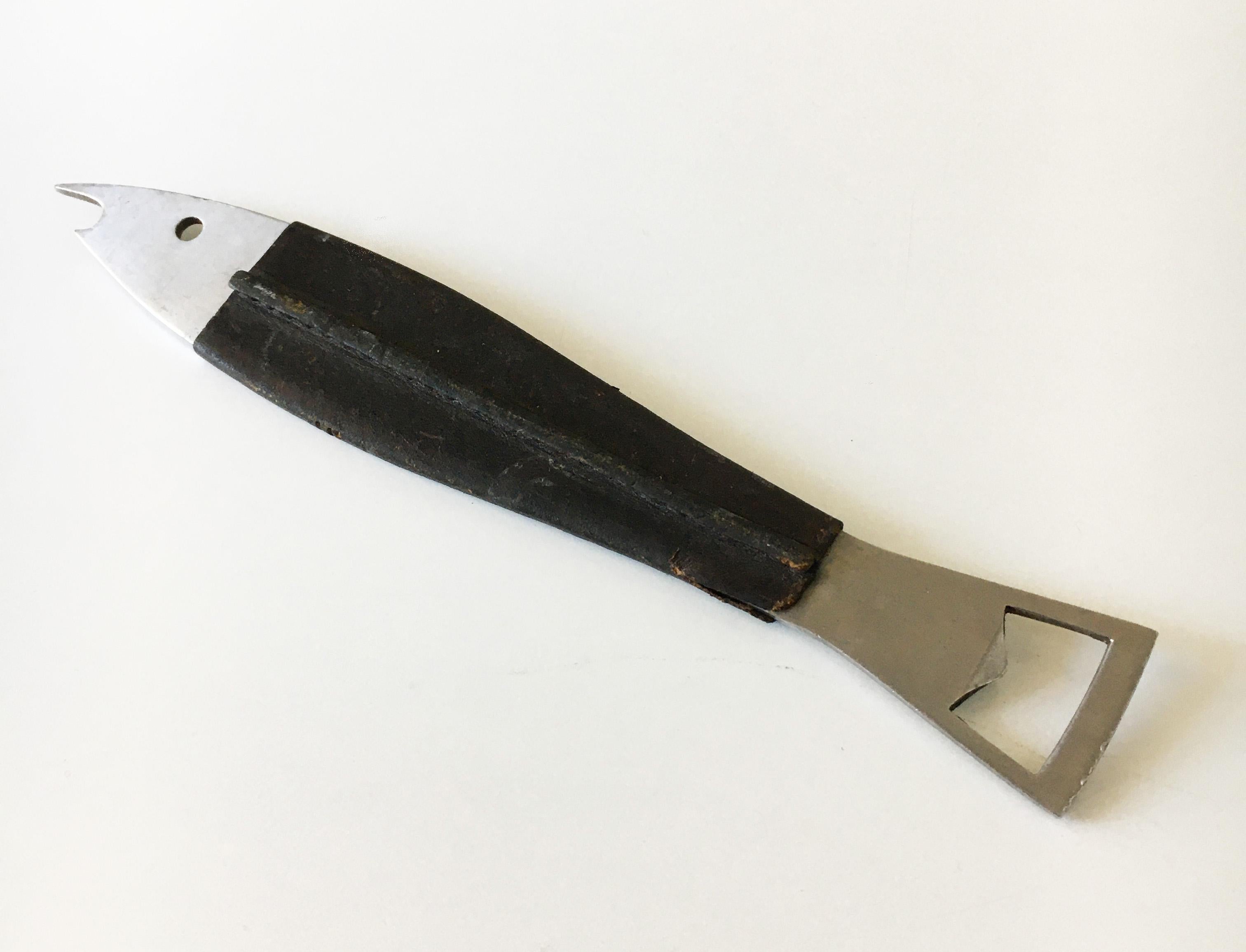 A beautiful fish-shaped modernist bottle opener from the 1950s 'Model No. 4687' made of stainless steel, covered with black leather. Designed by Carl Auböck. Executed by Amboss Austria. Some wear on the leather. Marked: AUBÖCK & STAINLESS AUSTRIA.
