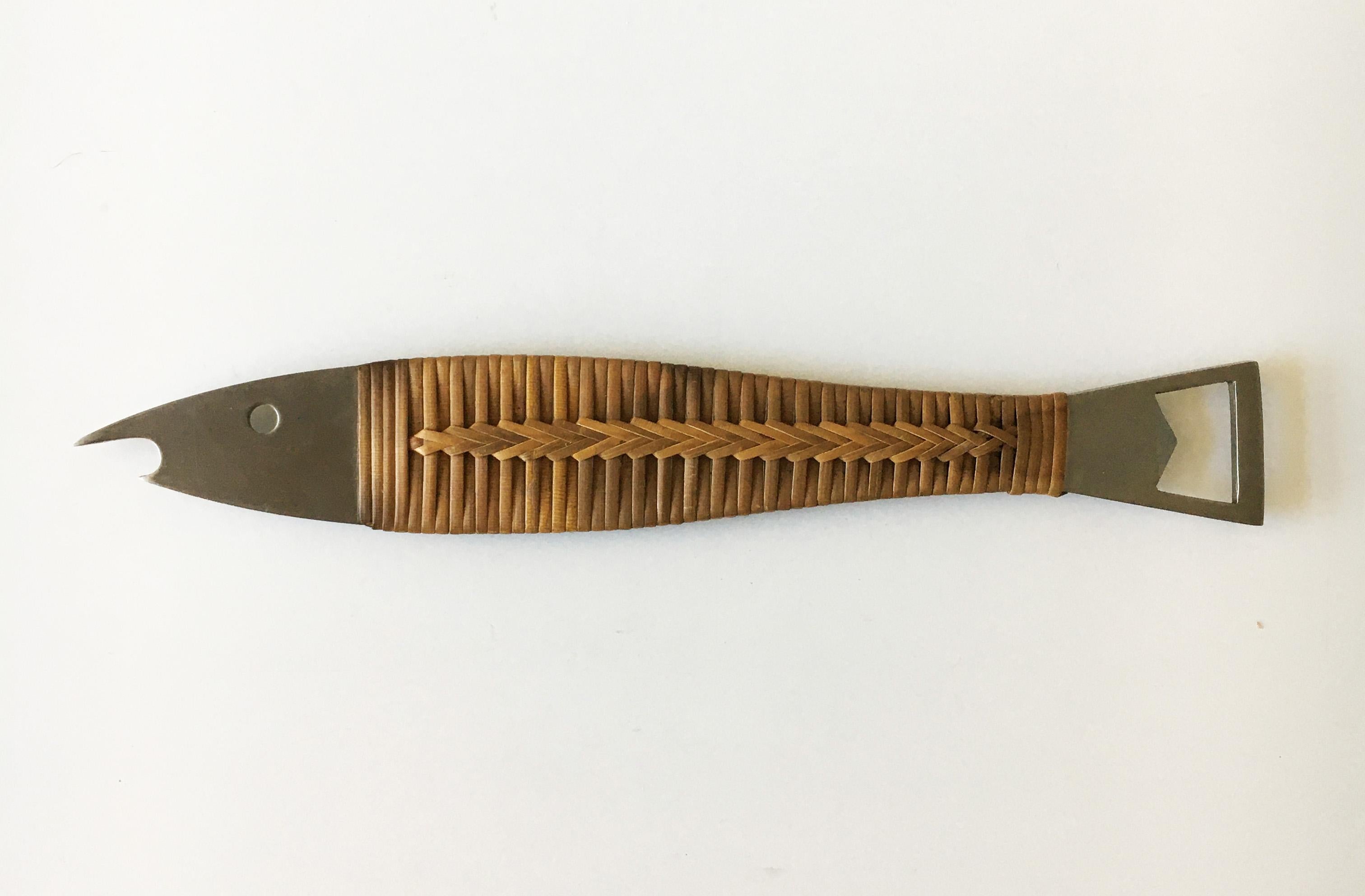 A beautiful fish-shaped modernist bottle opener from the 1950s 'Model No. 4687' made of stainless steel, covered with wrapped cane. Designed by Carl Auböck. Executed by Amboss Austria. Perfect condition to wicker and stainless steel body without any