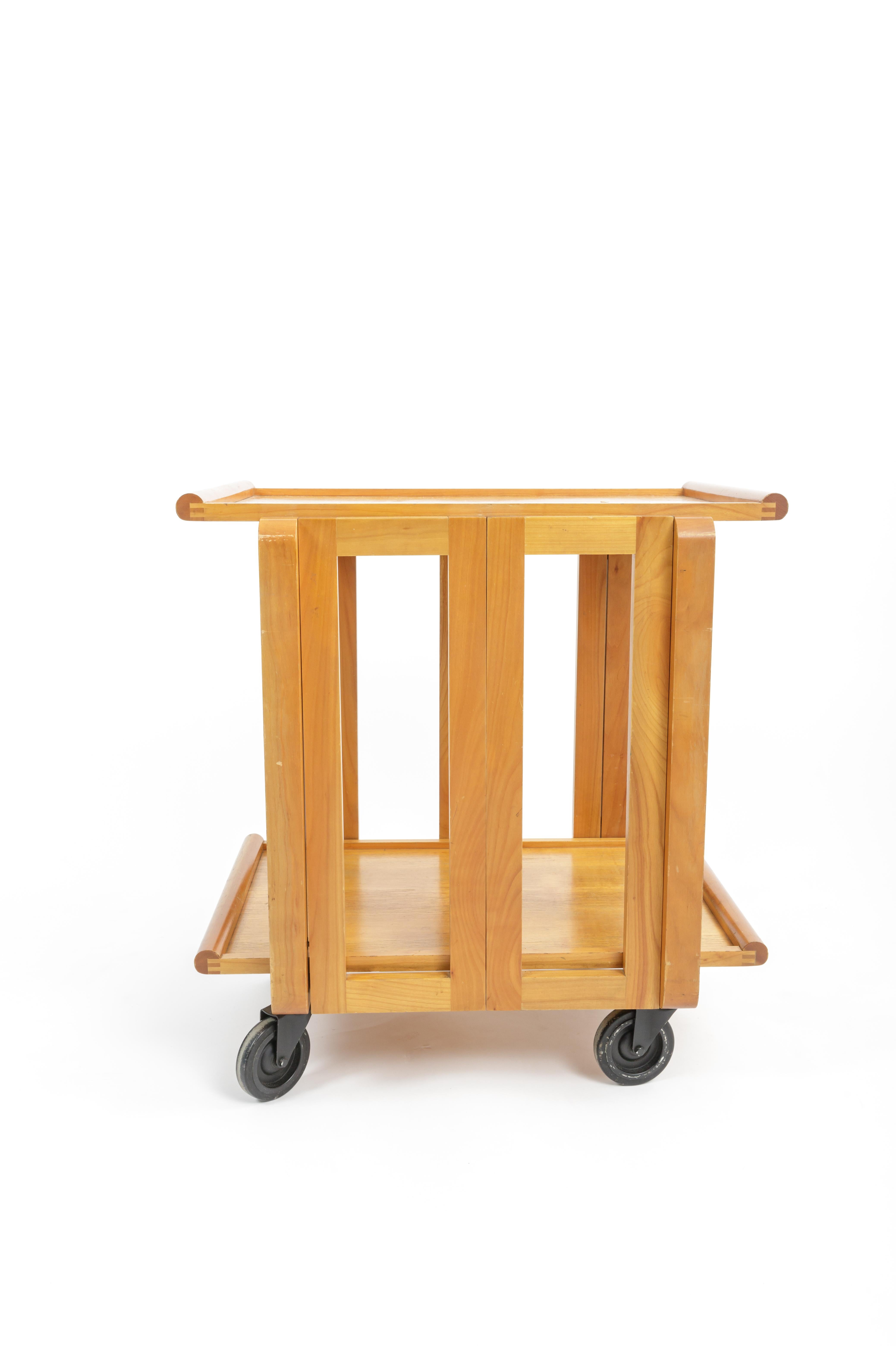 Carl Auböck III folding wooden tea trolley, Austria, circa 1980s 

Originally designed for the Culinar Ostovics, this tea trolley consists of two serving trays that allow the cart to fold flat for storage when removed. 

Sits on enameled steel