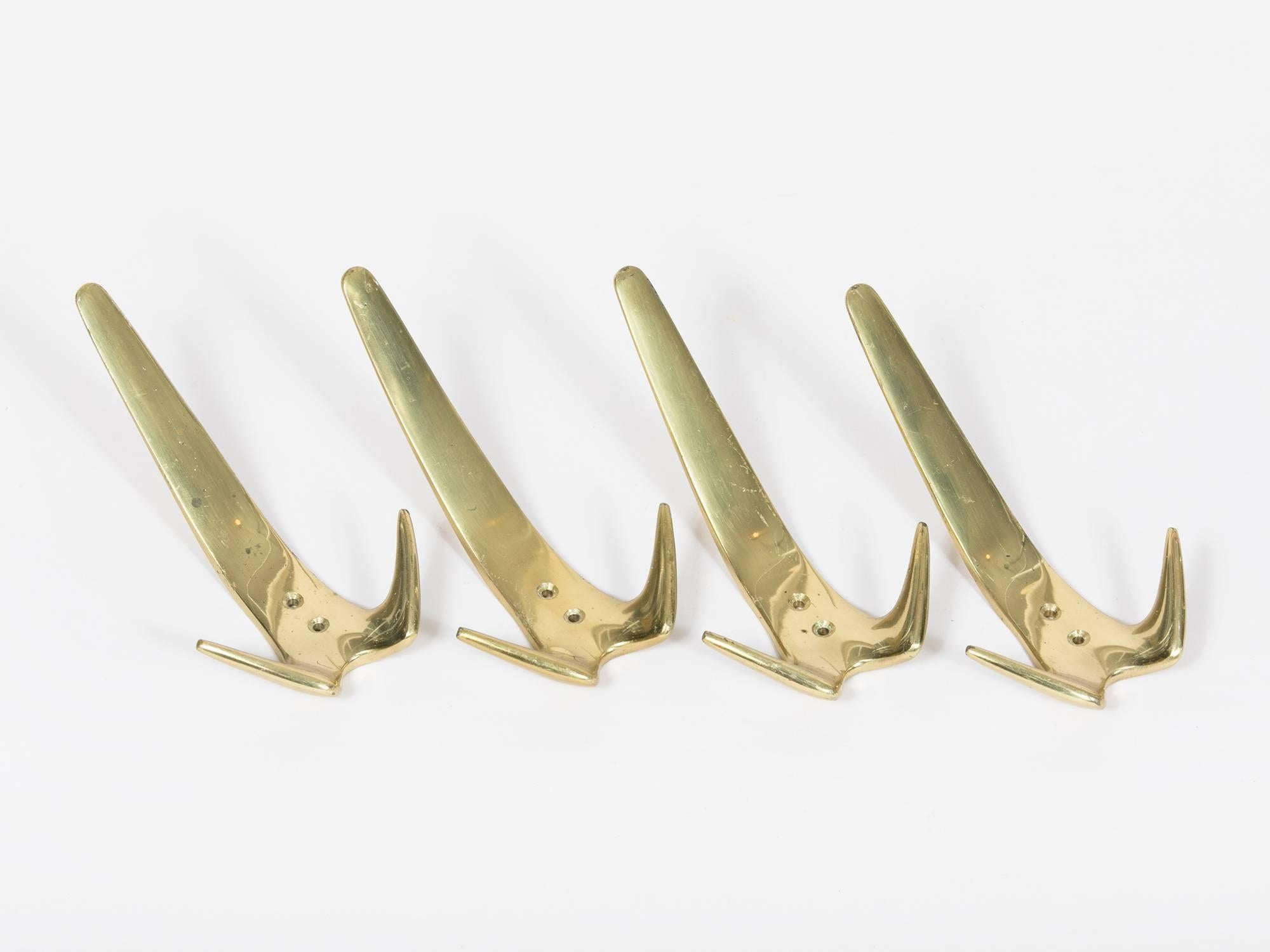 Large modernist cast brass wall hooks by Viennese designer Carl Auböck. Original works from the 1950s. Sold separately; four available.