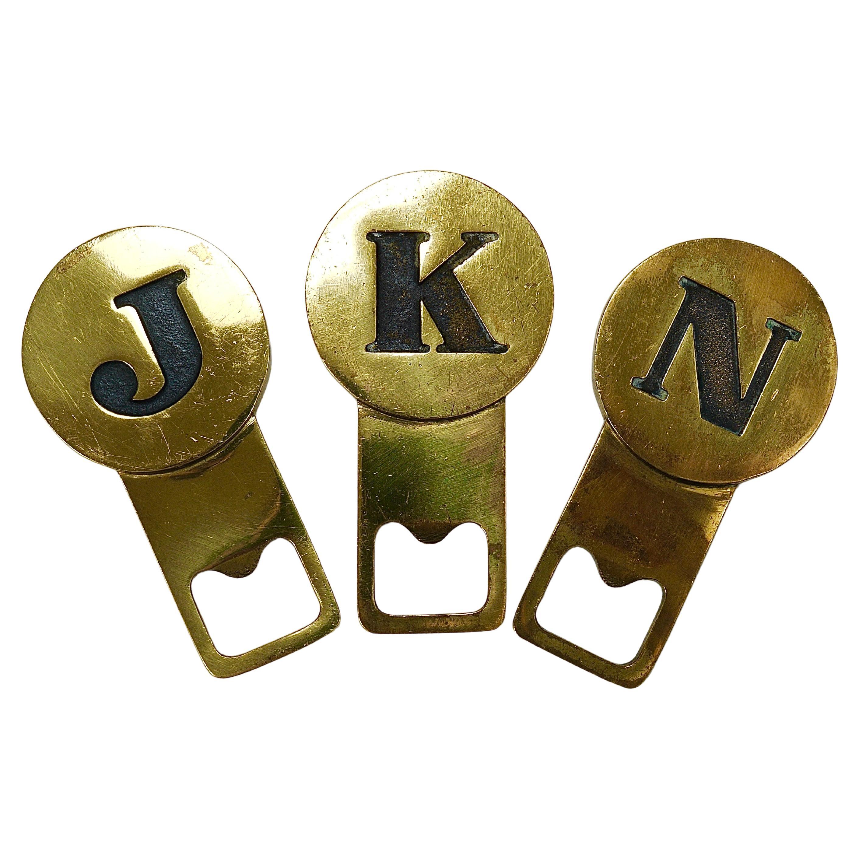 One (1) beautiful mid-century bottle opener featuring the initial 