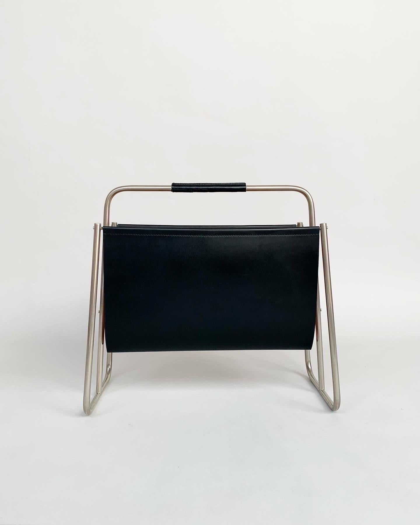 Carl Auböck magazine rack with a nickel plated frame and black leather, hand crafted by the Auböck workshop in Vienna, Austria in the 1950s.

Solid, hand-shaped with stitched leather. The leather is still very soft and unused, only a slightly
