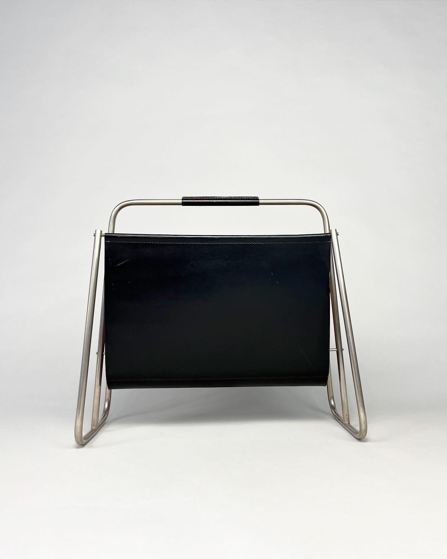 Carl Auböck magazine rack with a nickel plated frame and black leather, hand crafted by the Auböck workshop in Vienna, Austria in the 1950s. 

Solid, hand-shaped with stitched leather. The black leather is soft and patinated with a few marks and